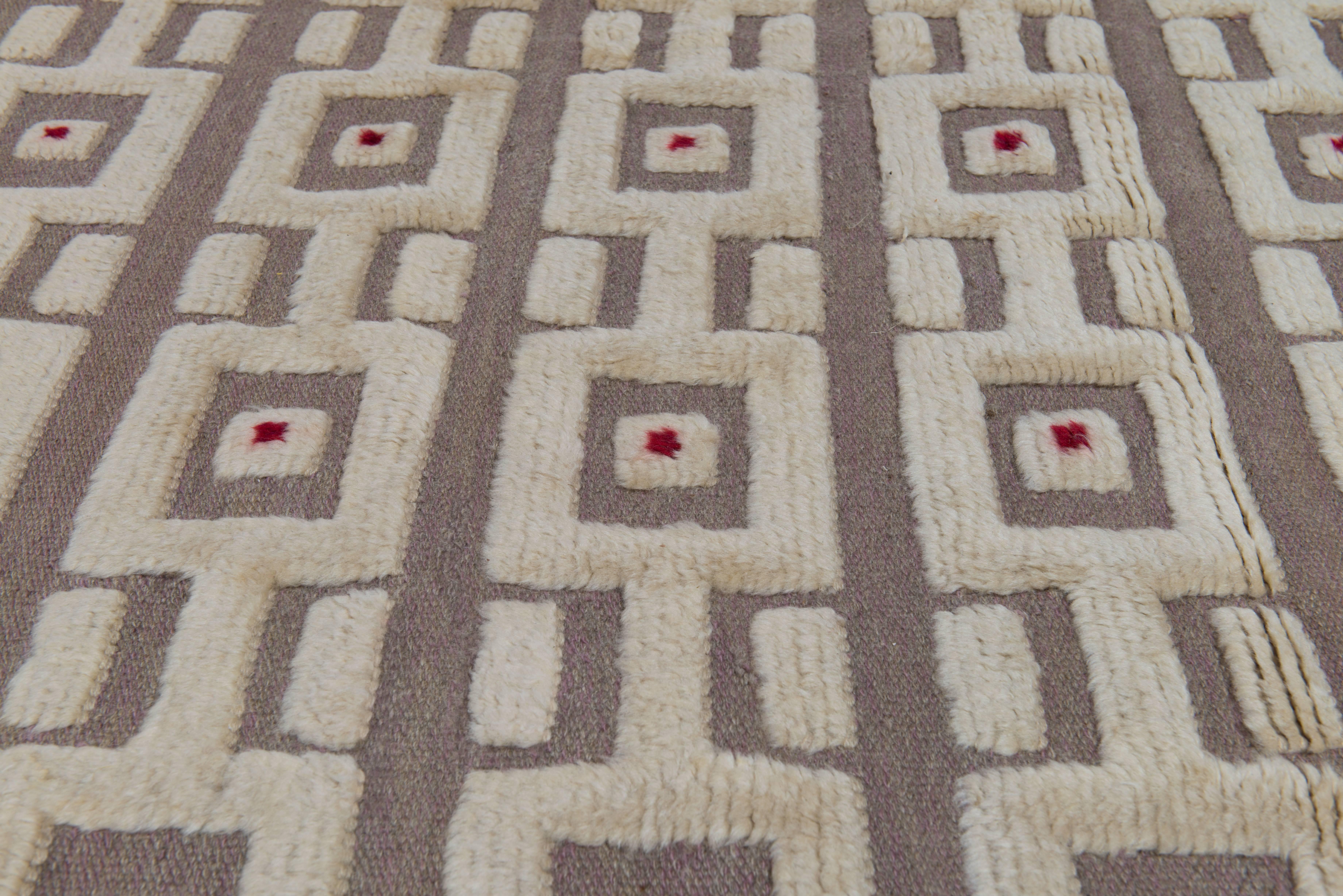 A truly beautiful and extremely rare example of a modernist Swedish carpet. A handwoven wool half pile carpet designed by Sigvard Bernadotte with wonderfully graphic motif in a elegant neutral palette with a contrasting red dot. One of Sweden's most