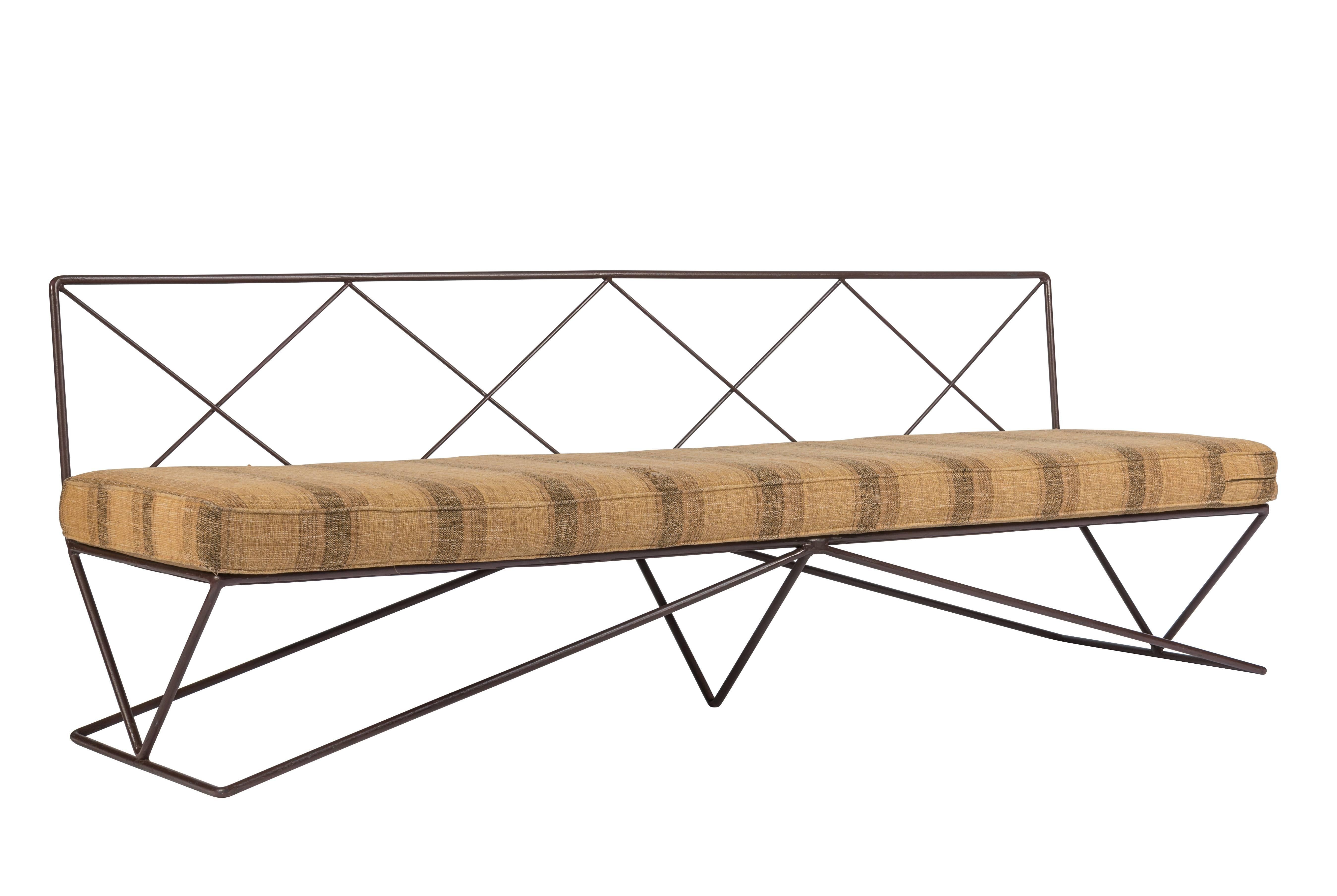 A rare Darrell Landrum wrought iron, steel, and fabric sofa for Avard Furniture Co., New York, New York, designed 1949, and produced circa 1955. The base is composed of 3 large connected triangles supporting a perforated metal deck, the back of