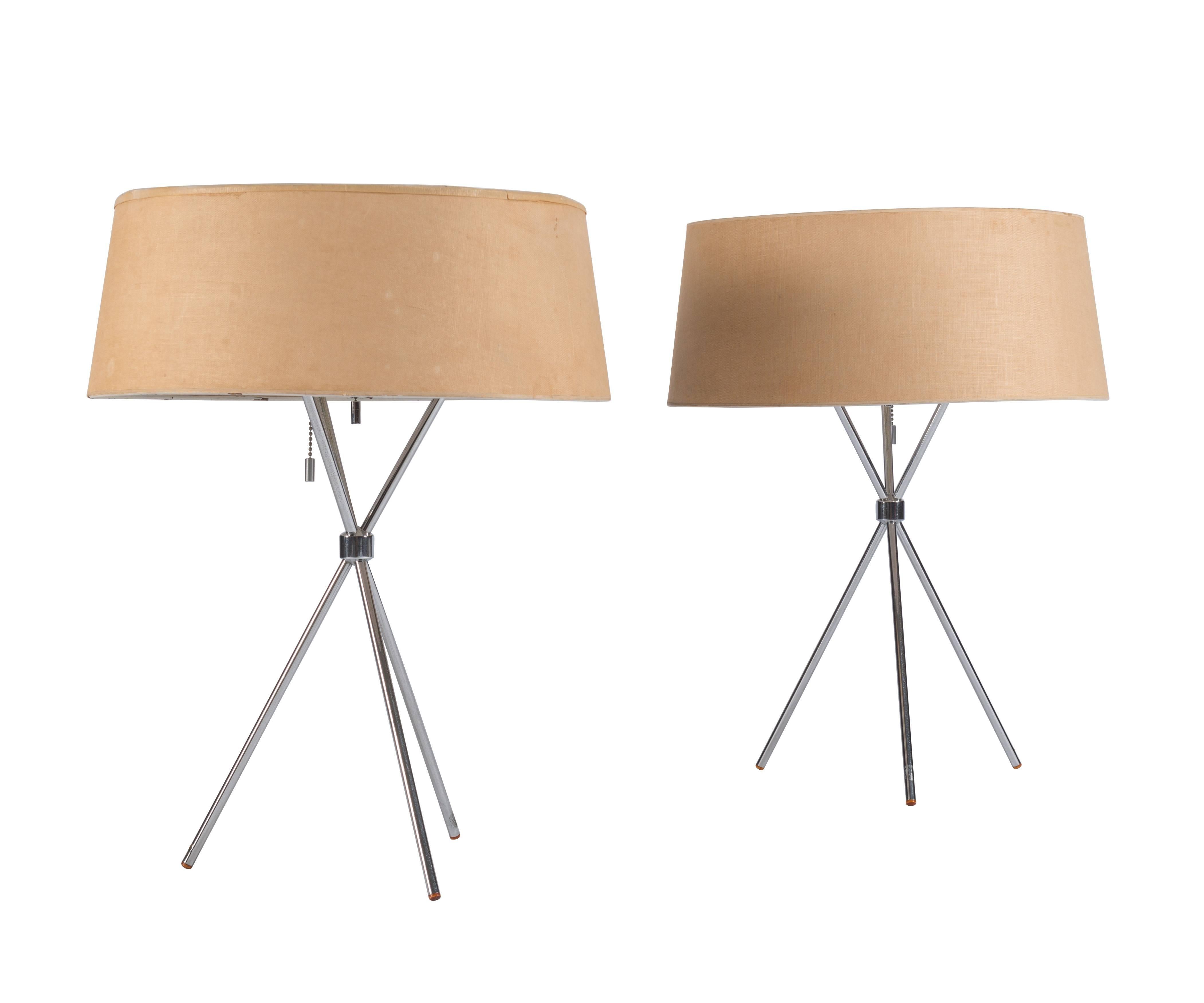 Pair of Robsjohn-Gibbings desirable brushed nickel tripod table lamps manufactured by Hansen Lighting Co. with original shades and signed diffusers.