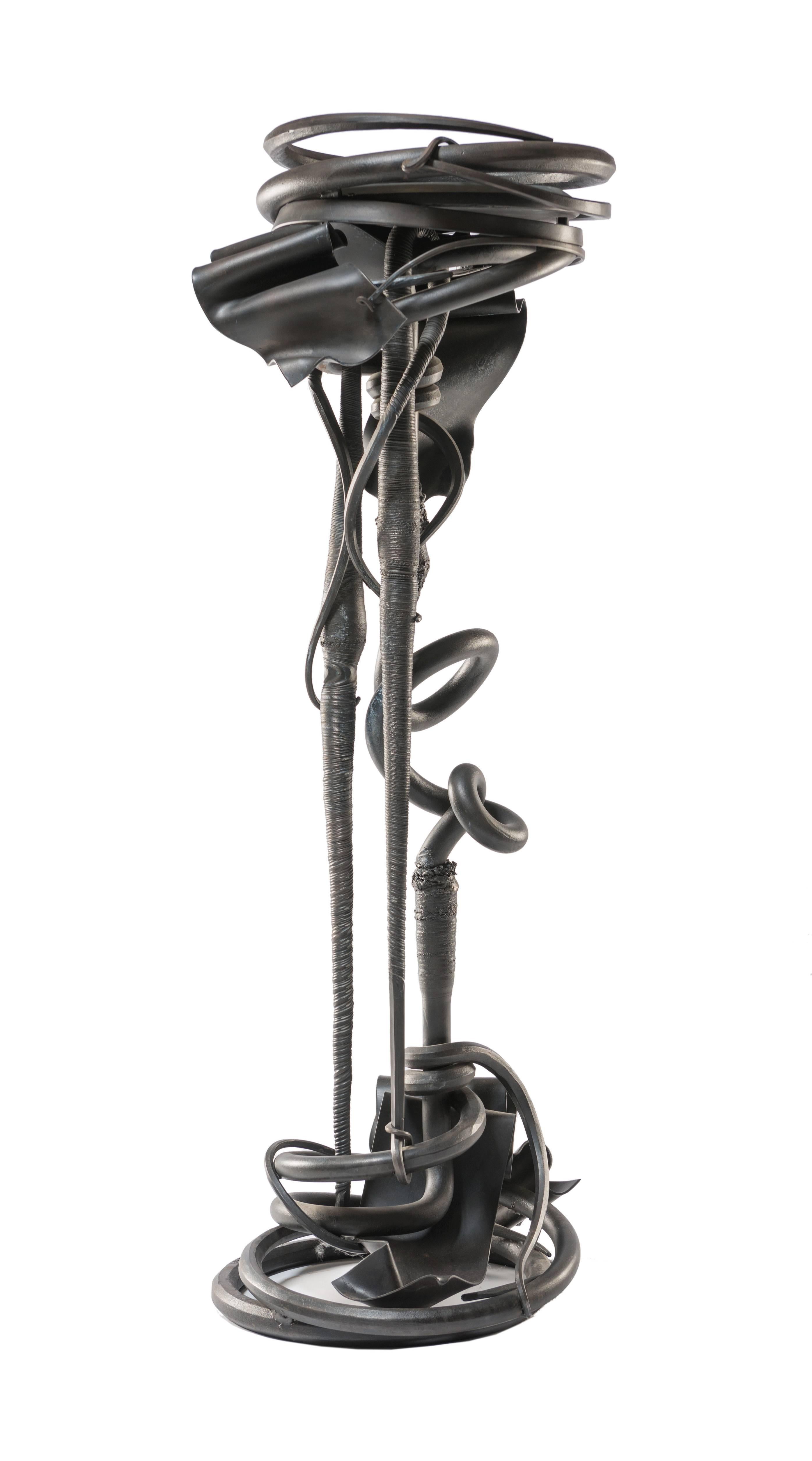 An excellent and early example of Albert Paley's work, this plant stand incorporates all of Paley's mastery of Ironwork. Includes original slate surface. Signed and dated 1989.