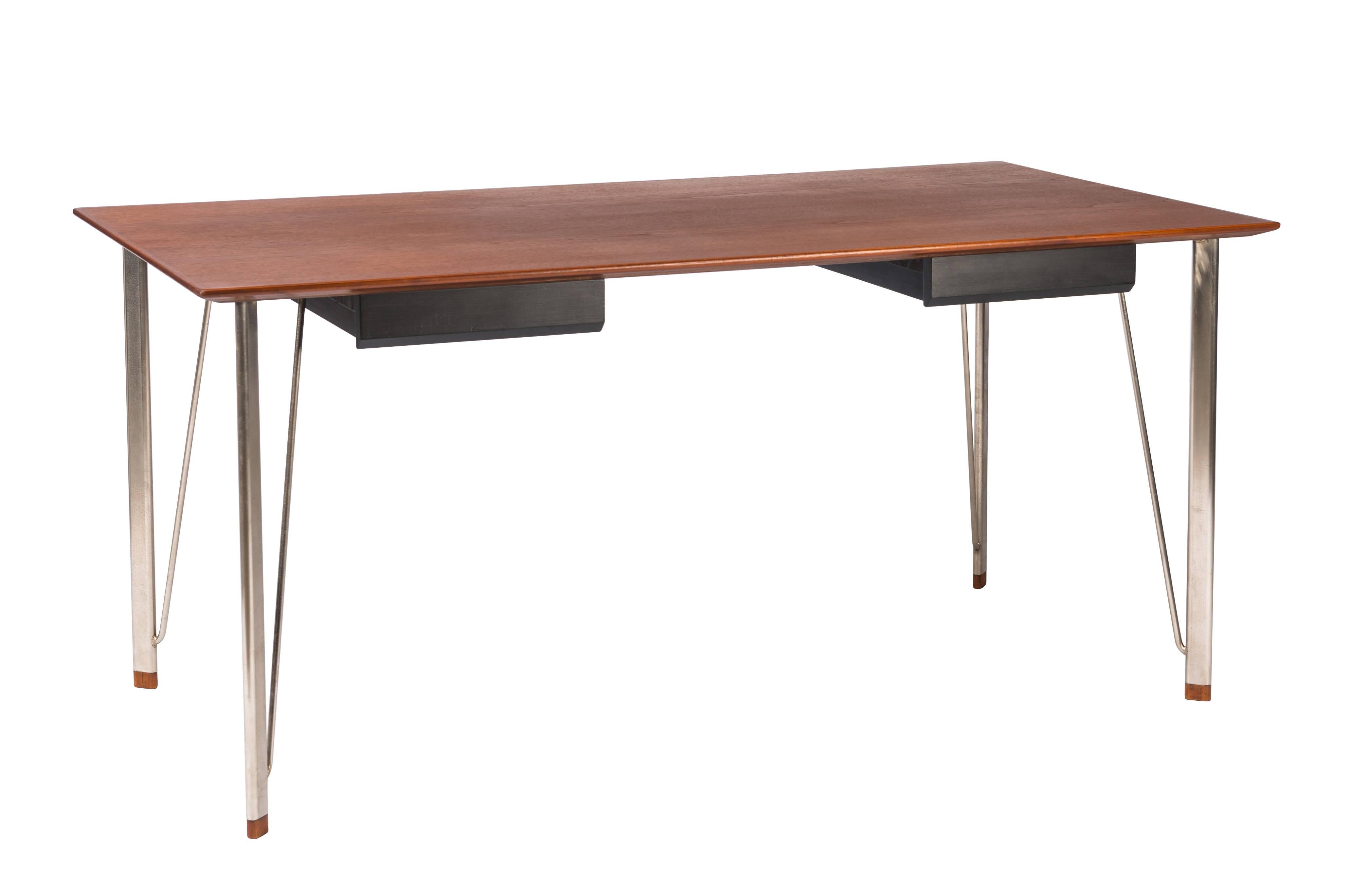 Rare teak desk designed by Arne Jacobsen, produced by Fritz Hansen in Denmark. Desk with two black drawers and teak tips to metal legs. Refinished.