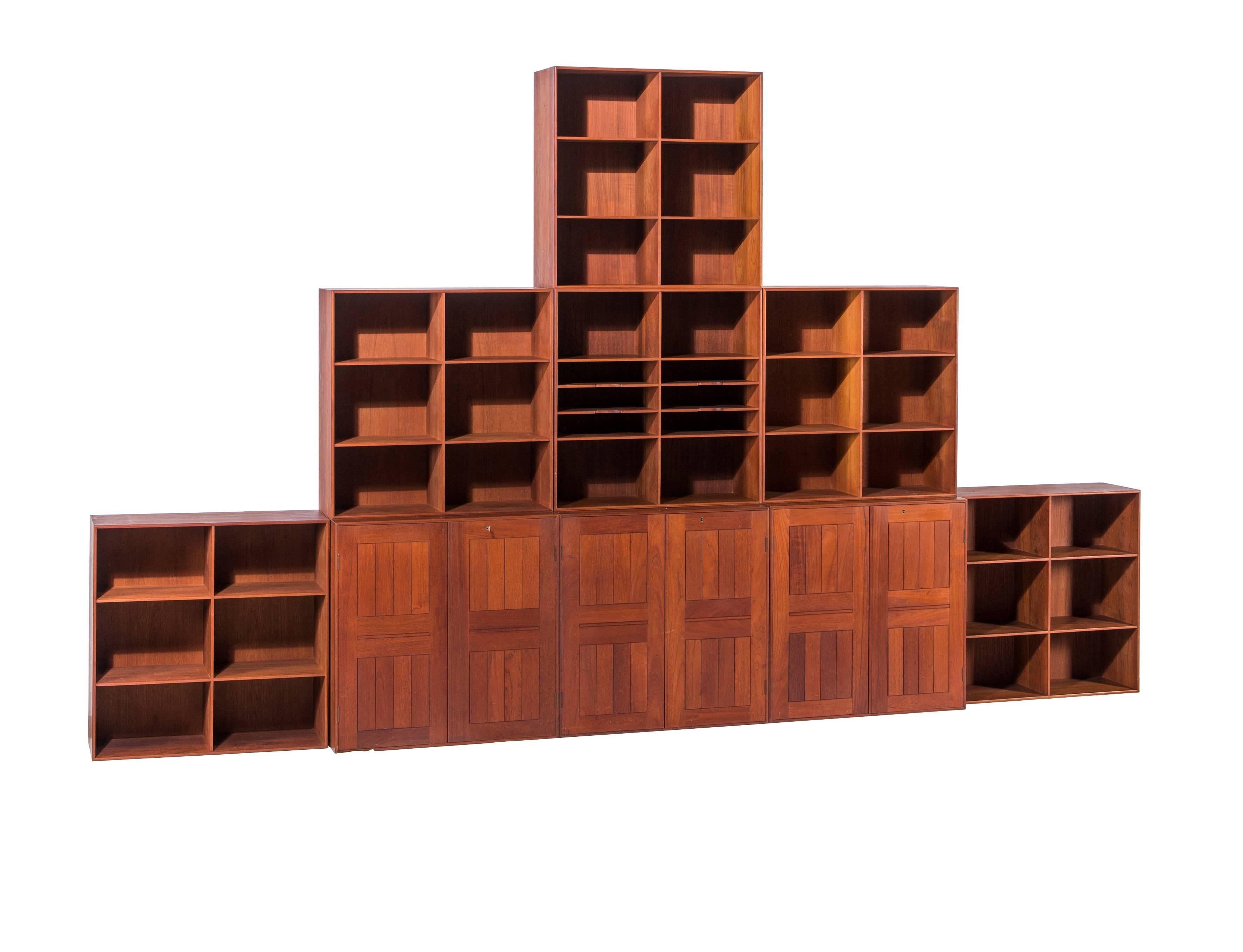 Massive set of Mogens Koch bookcases in rare teak. 12-piece bookcase with three cabinets with multiple interior storage and six open bookcases. All pieces have dovetailed joinery. With labels to back 
