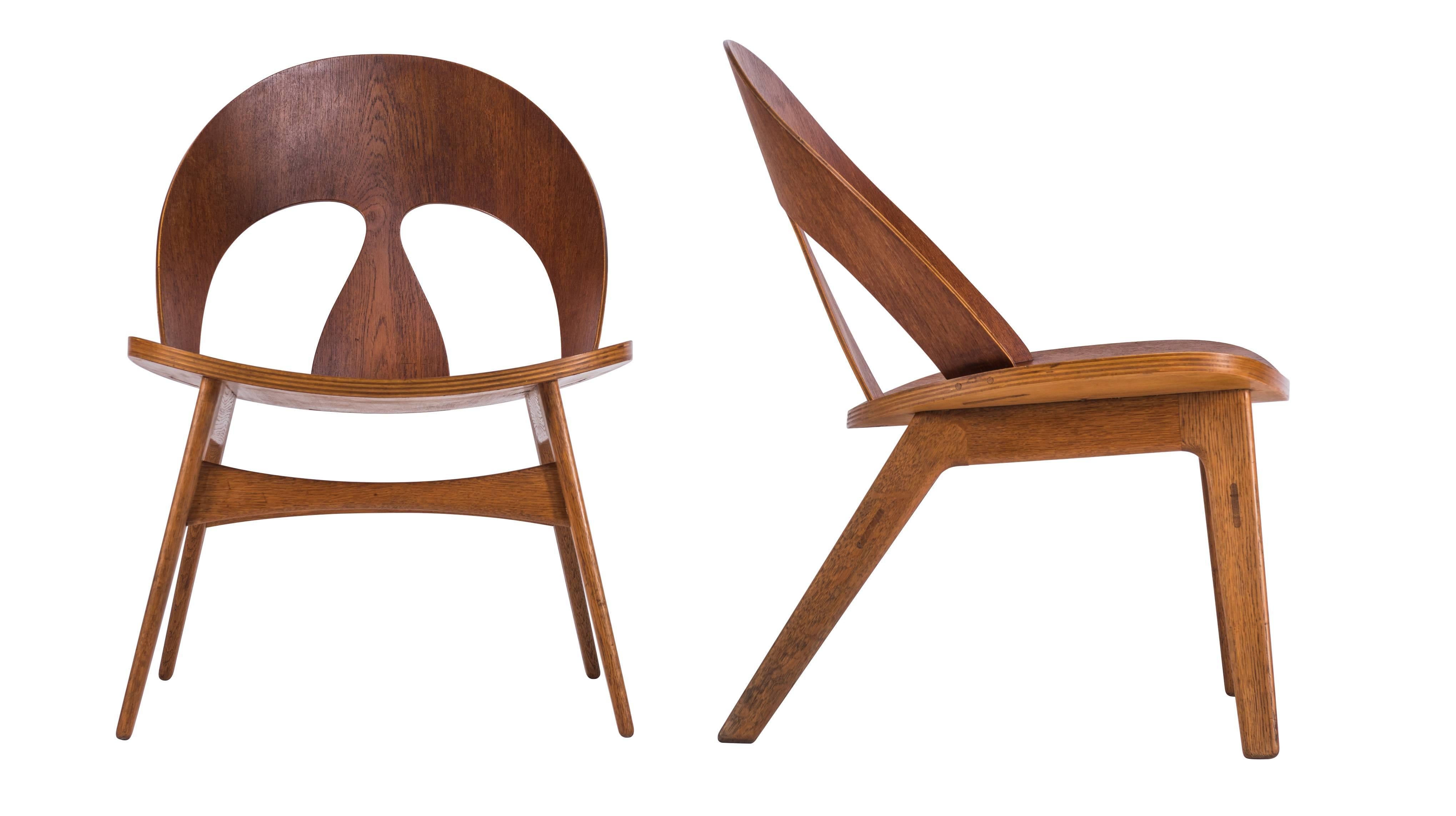 Rare and very early Mogensen plywood lounge chairs. Chairs with teak plywood seats and backs and oak legs. Signed with early Erhard Rasmussen labels.