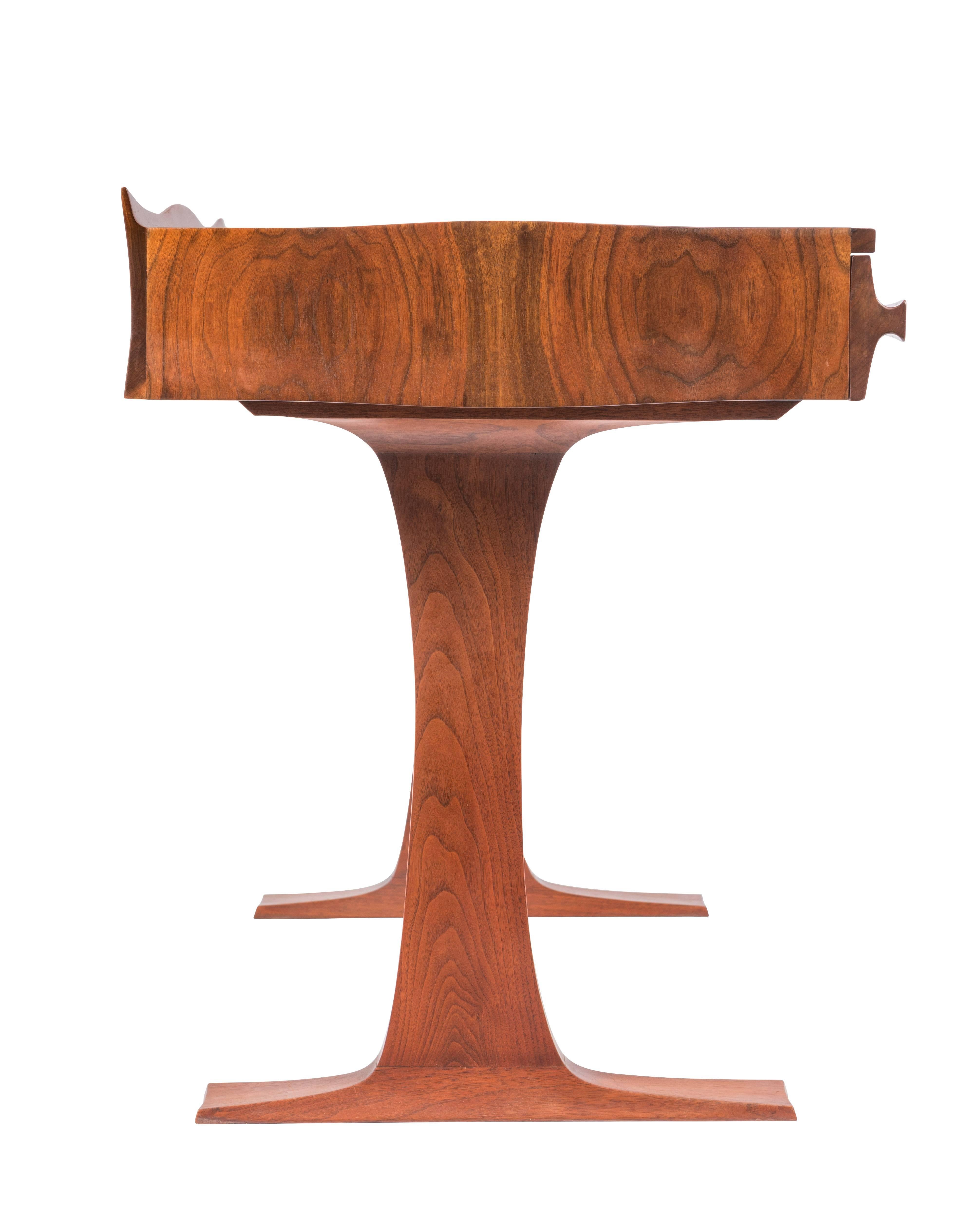 Hand-carved three-drawer walnut desk by Robert Whitley. This desk and the following listing are from a single owner named Florence Green, who commissioned Whitley to create a large collection of his work between 1965-1975 for her home in PA. Desk is