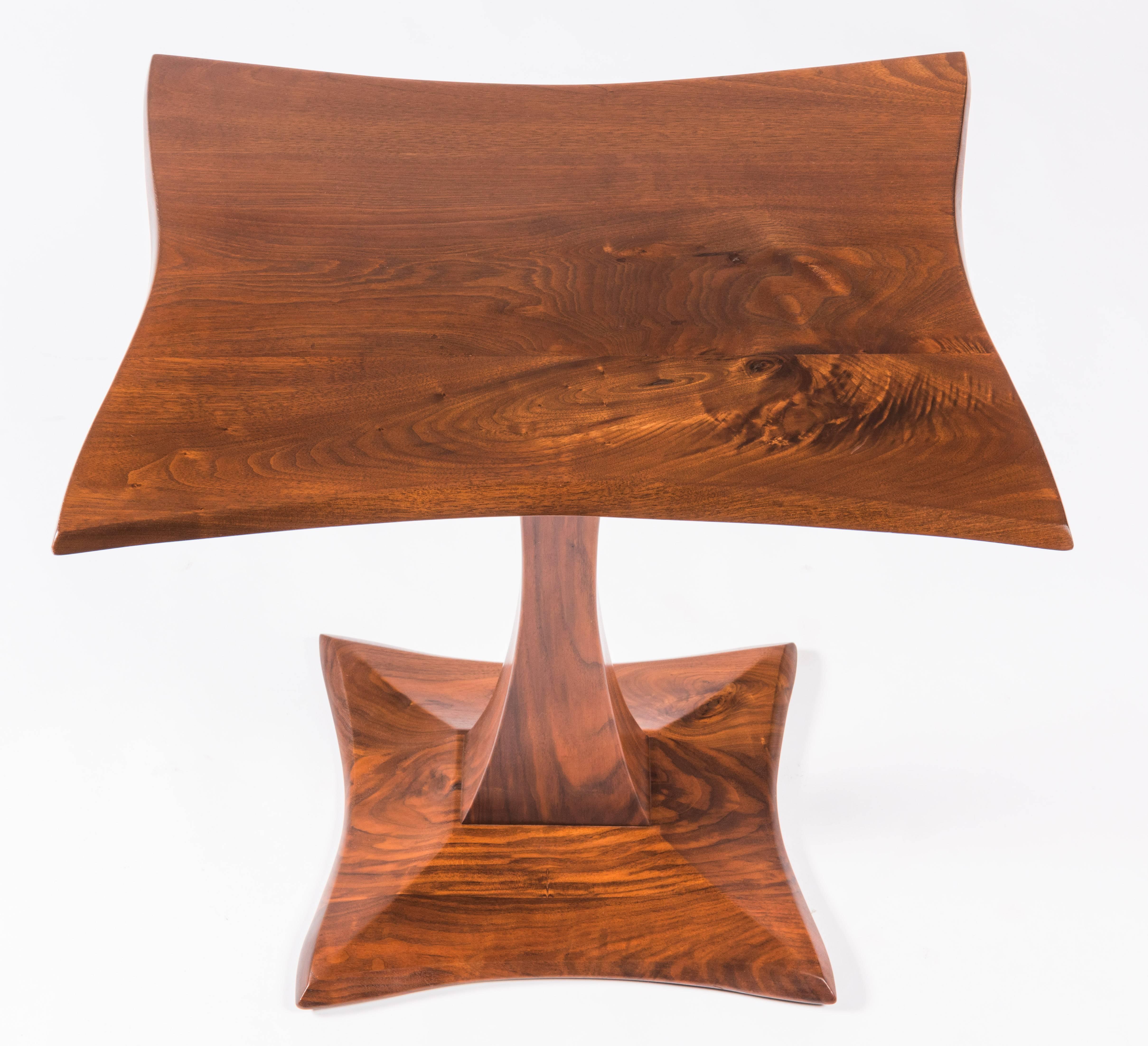 Pair of hand-carved walnut end or side tables by Robert Whitley. These tables and the following listing are from a single owner named Florence Green, who commissioned Whitley to create a large collection of his work between 1965-1975 for her home in