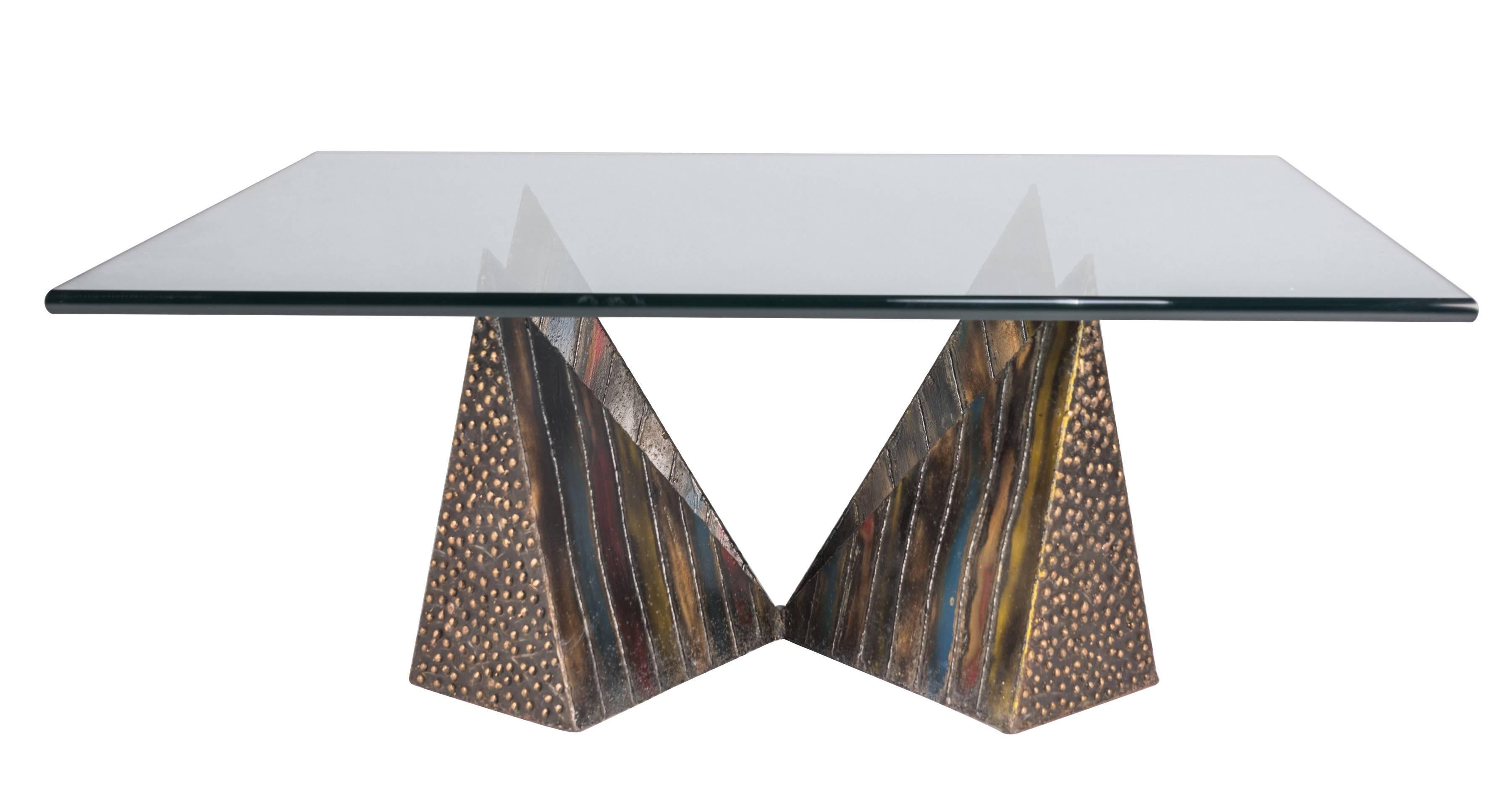 Pyramid coffee table by Paul Evans with his iconic patinated steel base and a glass top. This example from 1973 features especially expressive and bright patination colors. A rare example of the iconic form.