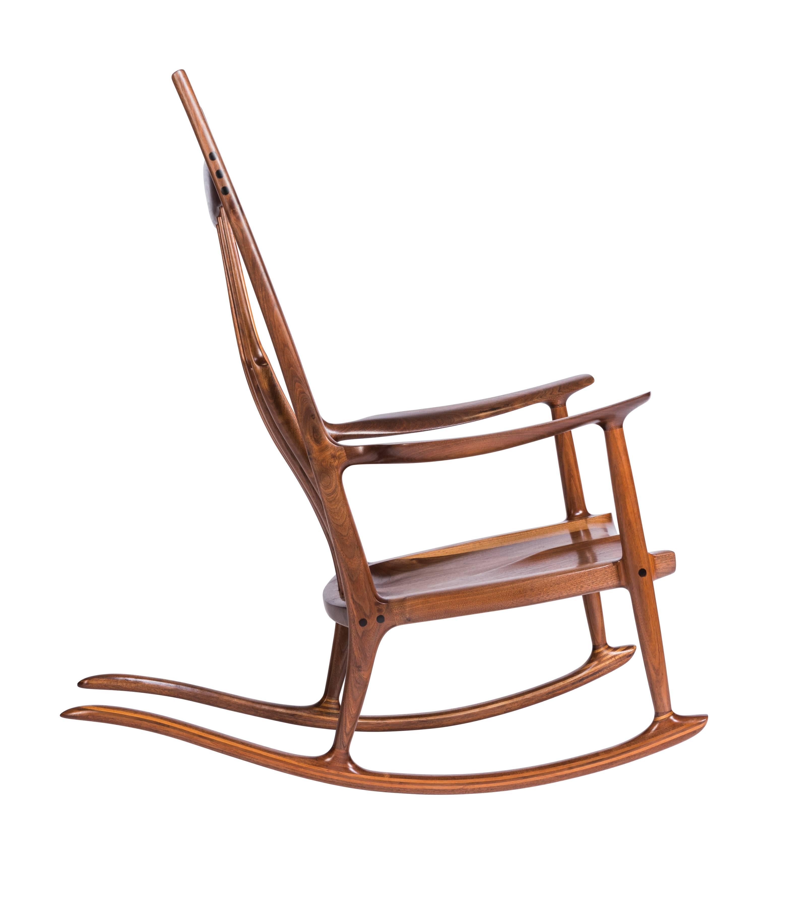 A perfect and unique example by noted California woodworker Sam Maloof. His iconic rocker defined his work and were made for two U.S. Presidents and dignitaries globally. Constructed in walnut with ebony inlay, creating a beautiful contrast of
