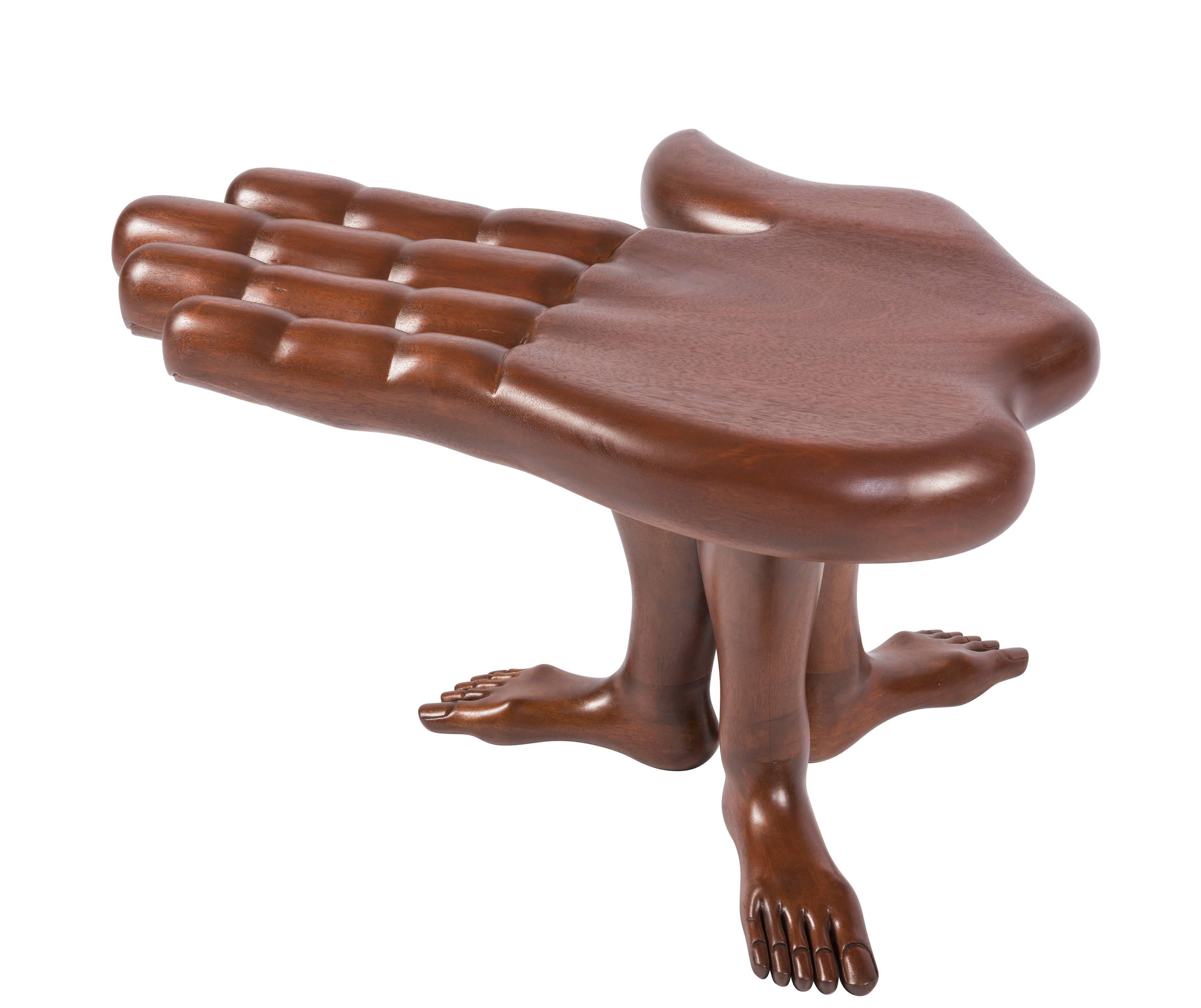 A rare hand and foot table or stool designed and made by Mexican Surrealist artist Pedro Friedeberg in his iconic hand and leg motif. Made of laminated and blocked mahogany, this table/stool features a palm supported by three legs and feet. Signed