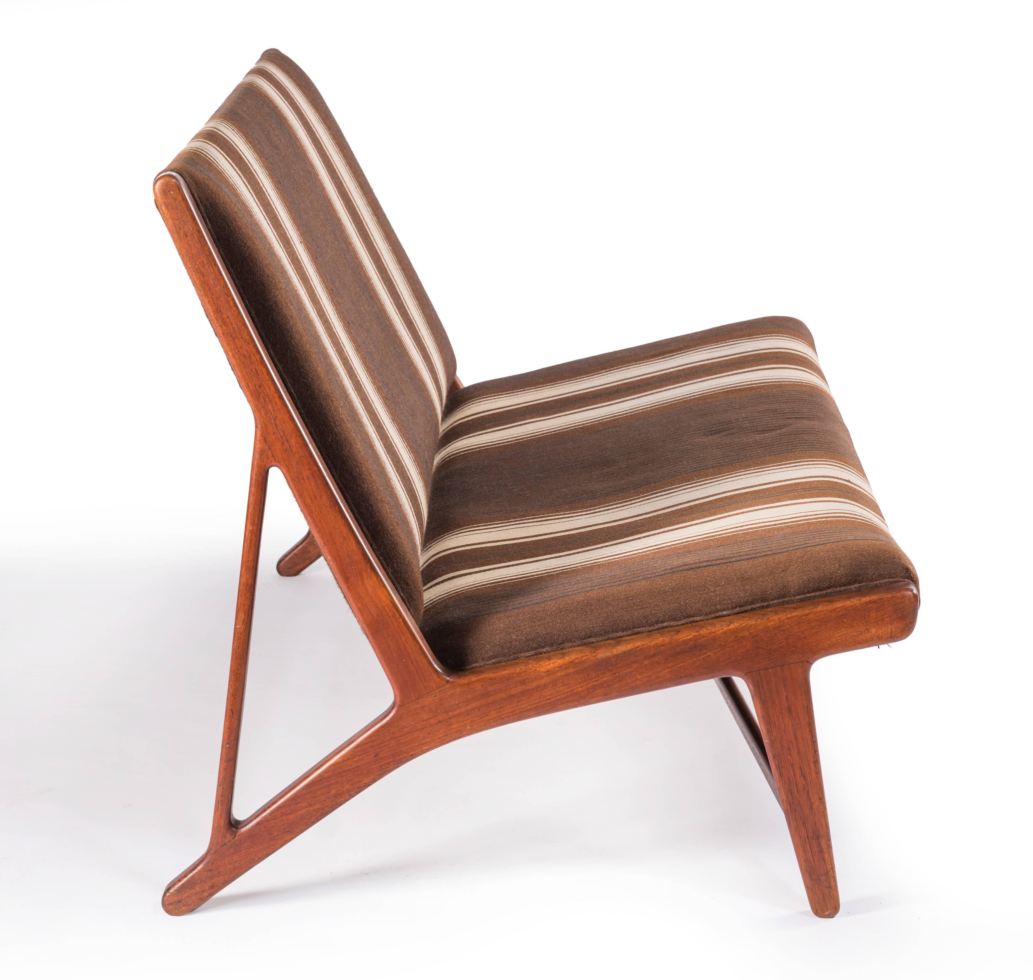 A beautiful and rare example of Model JH555, an armless settee in original wool fabric on teak frame designed by Hans Wegner in 1949 for Johannes Hansen, Denmark. Signed.