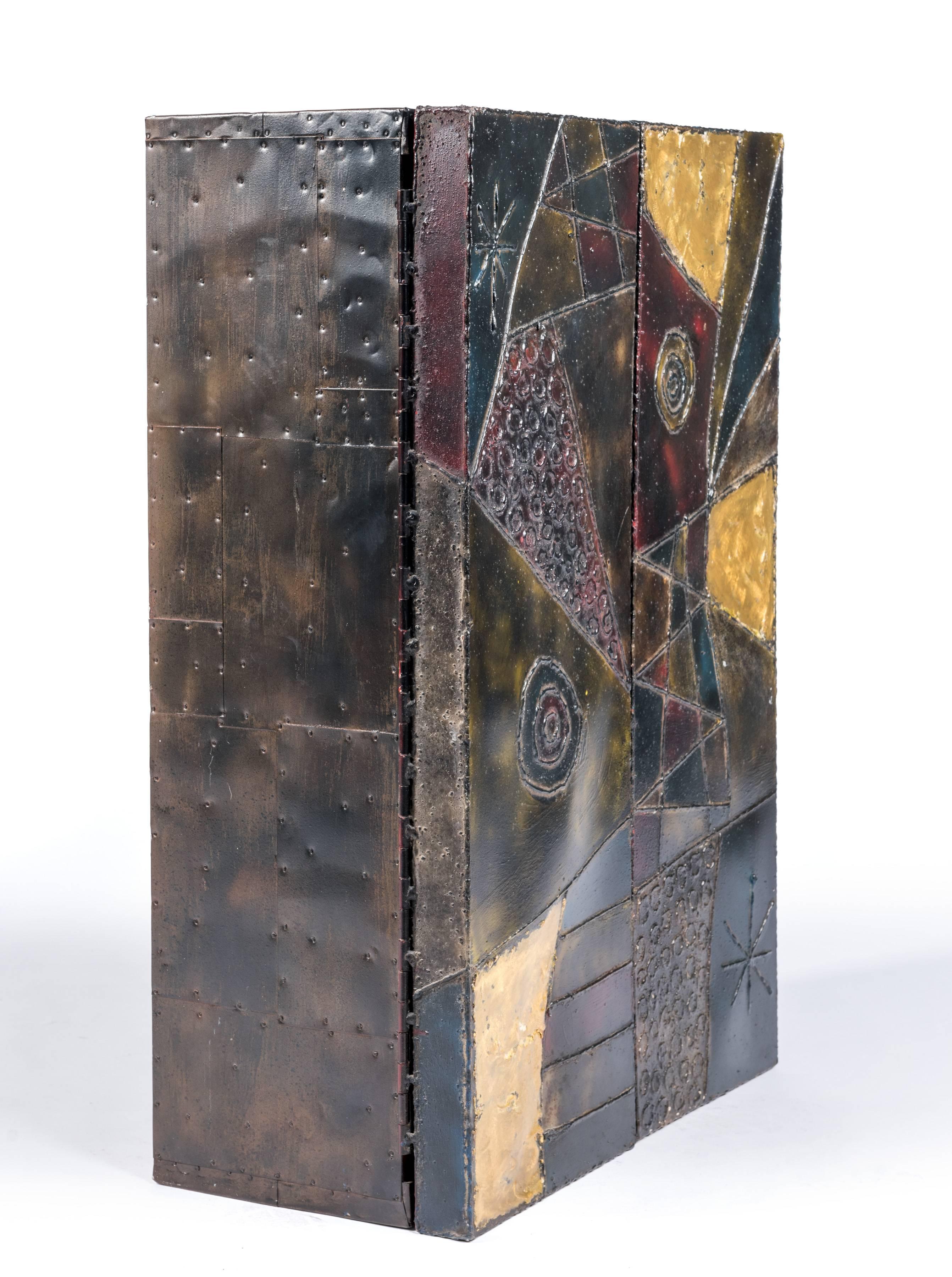 Sculpted steel wall-mounted cabinet by Paul Evans. Cabinet with original color to exterior and interior finished with hand-painted red lacquer and three adjustable shelves. Signed and dated 