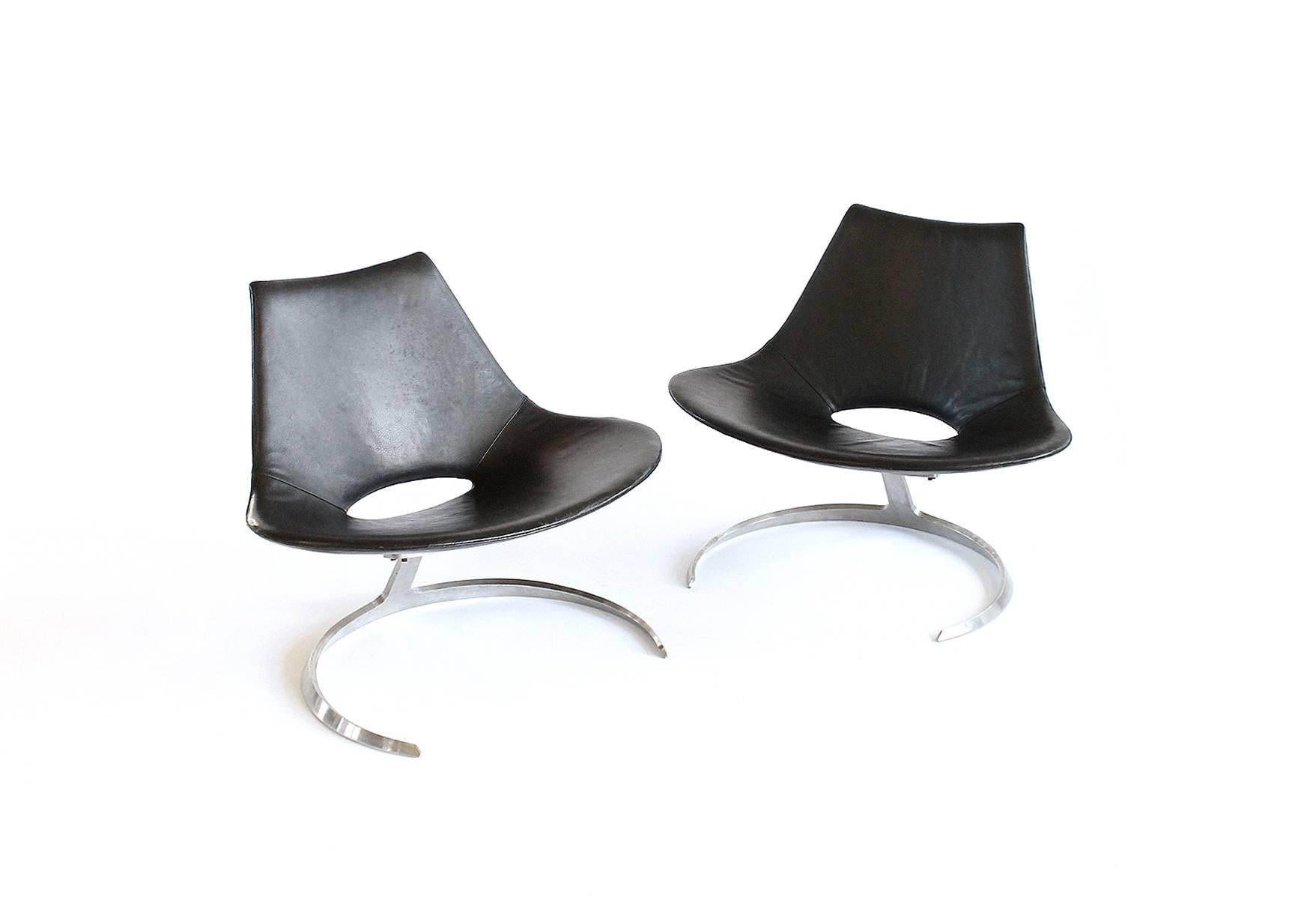 Beautiful and rare pair Preben Fabricius & Jørgen Kastholm 'Scimitar' lounge chairs with stainless steel frames and original black leather upholstery. Designed in 1962 with inspiration from a Turkish scimitar. Produced and stamped by Ivan