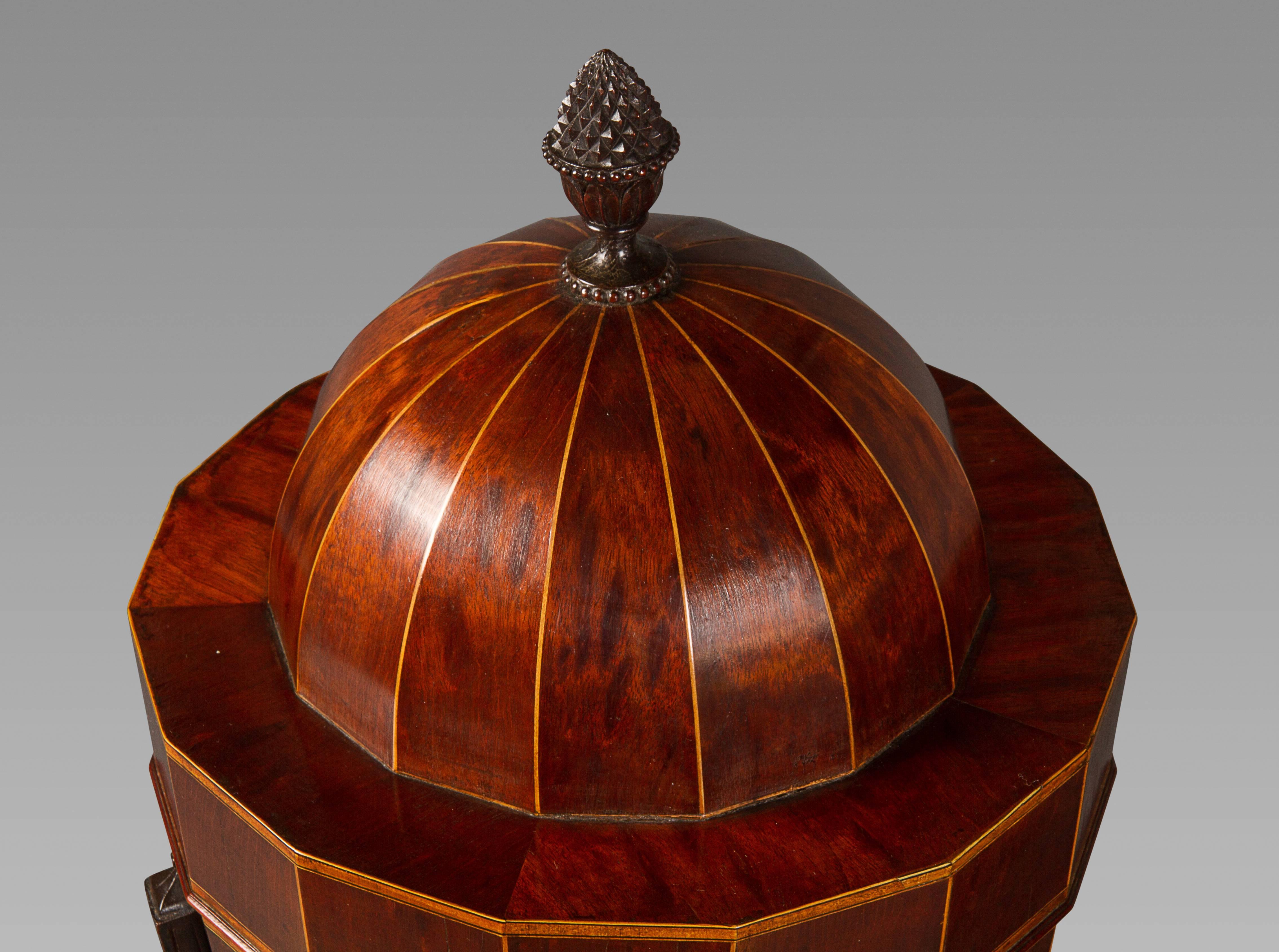 A very impressive pair in well-figured mahogany and boxwood stringing. These urns have the unusual feature of three beaded and curved supports from the urns to the circular base which is indicative of the Hepplewhite attribution. Interestingly,