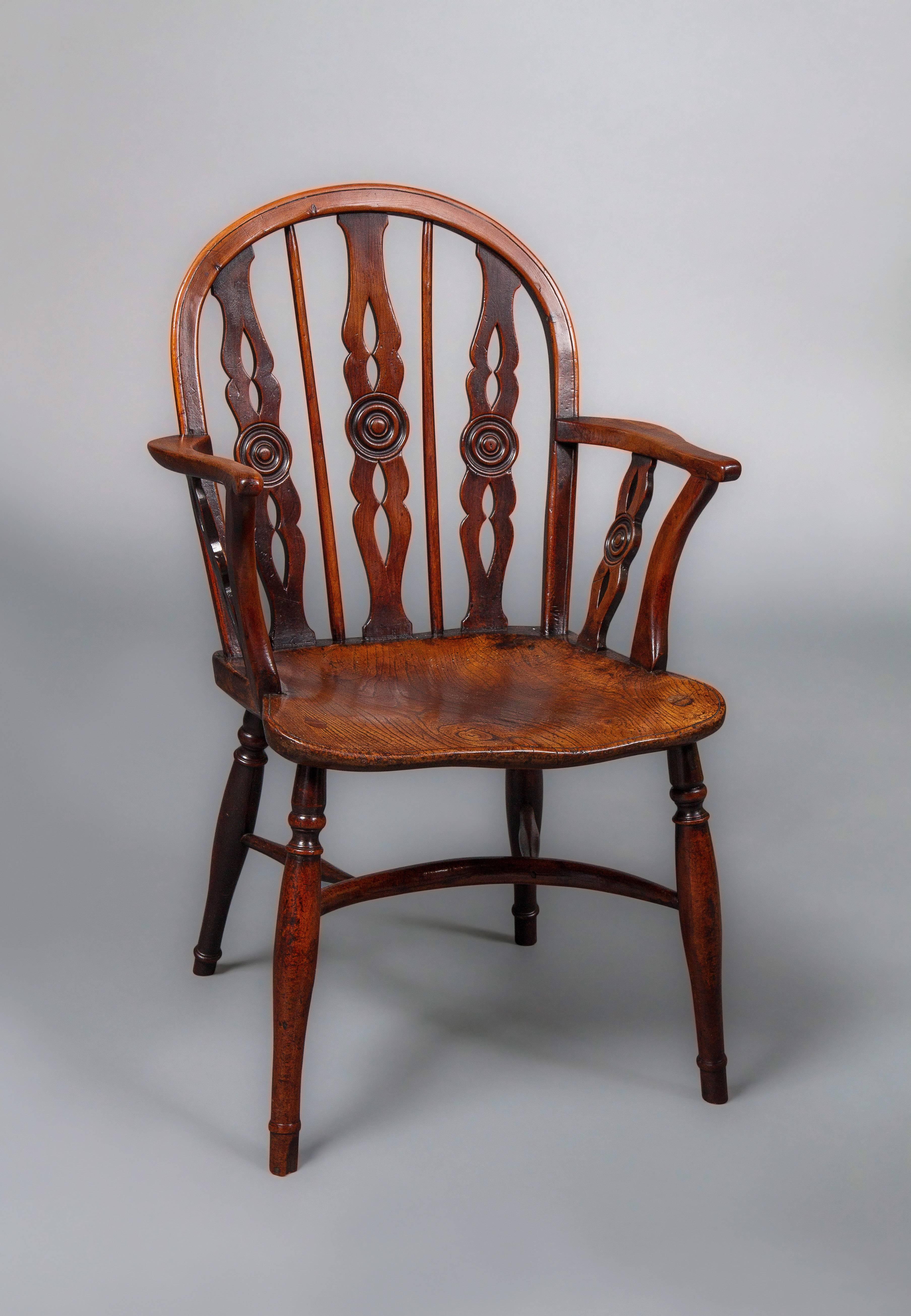 Attributed to the Prior family of Uxbridge, Middlesex In the Thames Valley, this set consists of two armchairs and six side chairs.

Each chair with a hooped back in yew wood with vertical pierced splats centered by roundels and shaped saddle seat