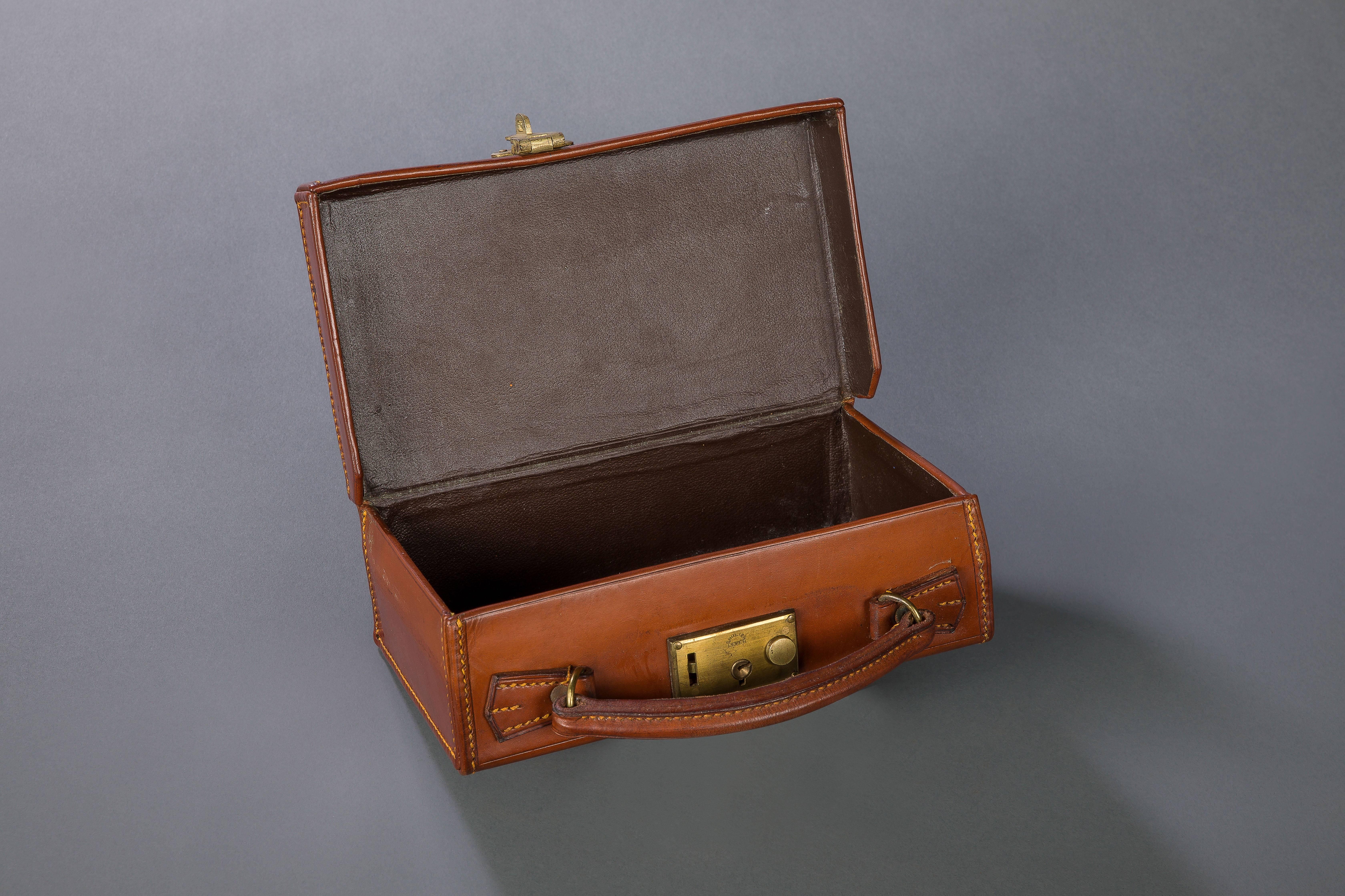 A very well made small size hide case in great condition and of superior quality. Brass locks stamped English lever.