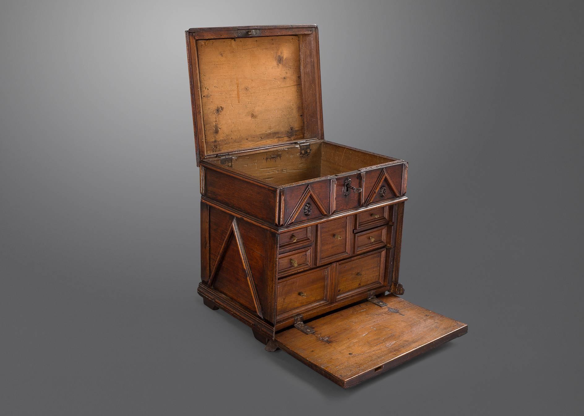 With decorative moldings and applied pyramided bossed through the primary wood being walnut with chestnut and deal on secondary woods. This is a fascinating cabinet and was clearly designed to contain valuables and important documents. There is one