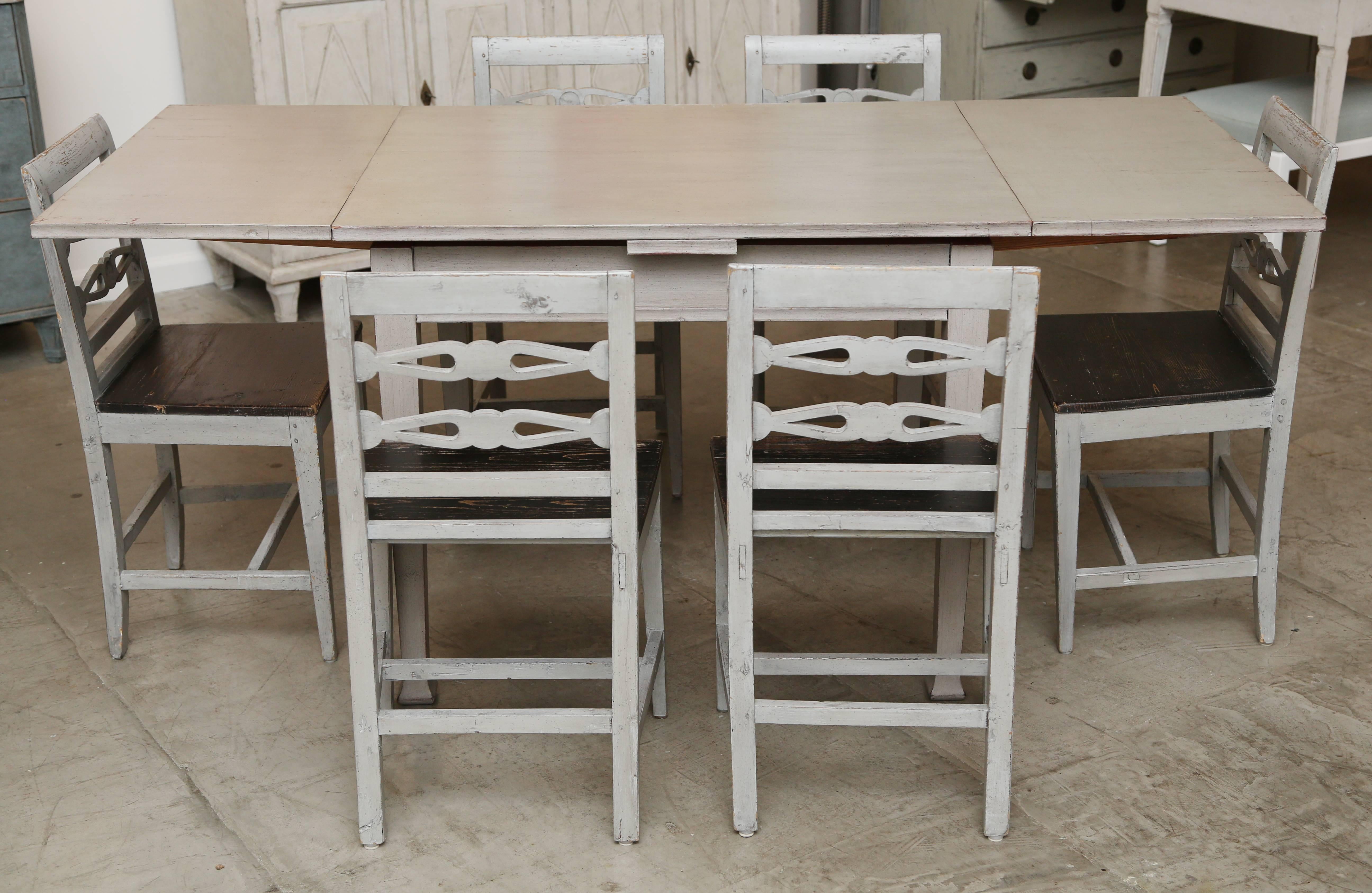 This antique Swedish dining table is wonderfully unique.
It is expandable and can seat six comfortably.
Useful as a breakfast table or where space is limited.
Painted grey.

Measures: 30.00'' H x 37.25'' W x 31.25'' D   68.50'' fully open

The six
