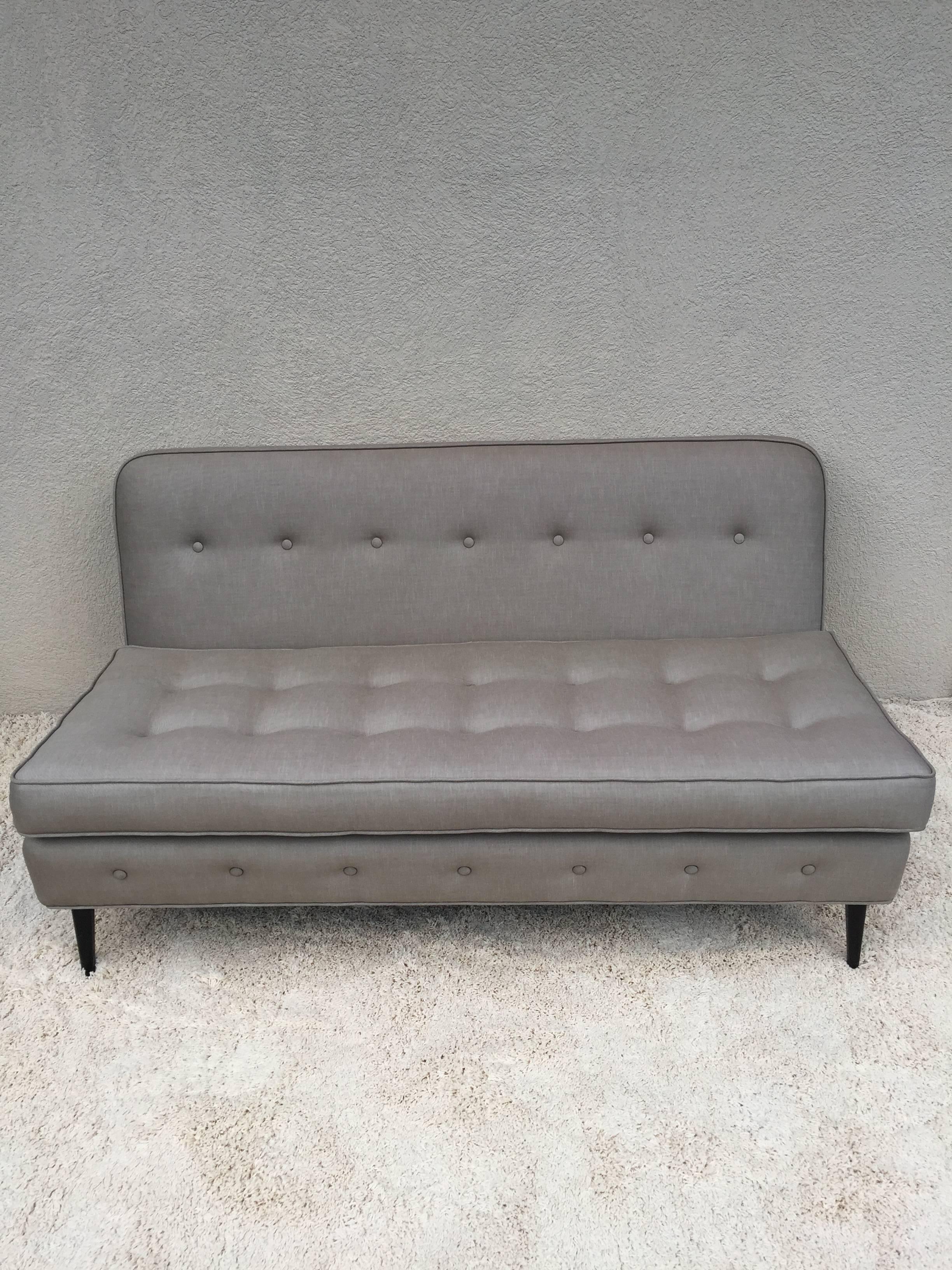 Paul McCobb style grey button tufted designed back front edge and cushion, five-leg sofa with slight angled back. Dark walnut finish legs.