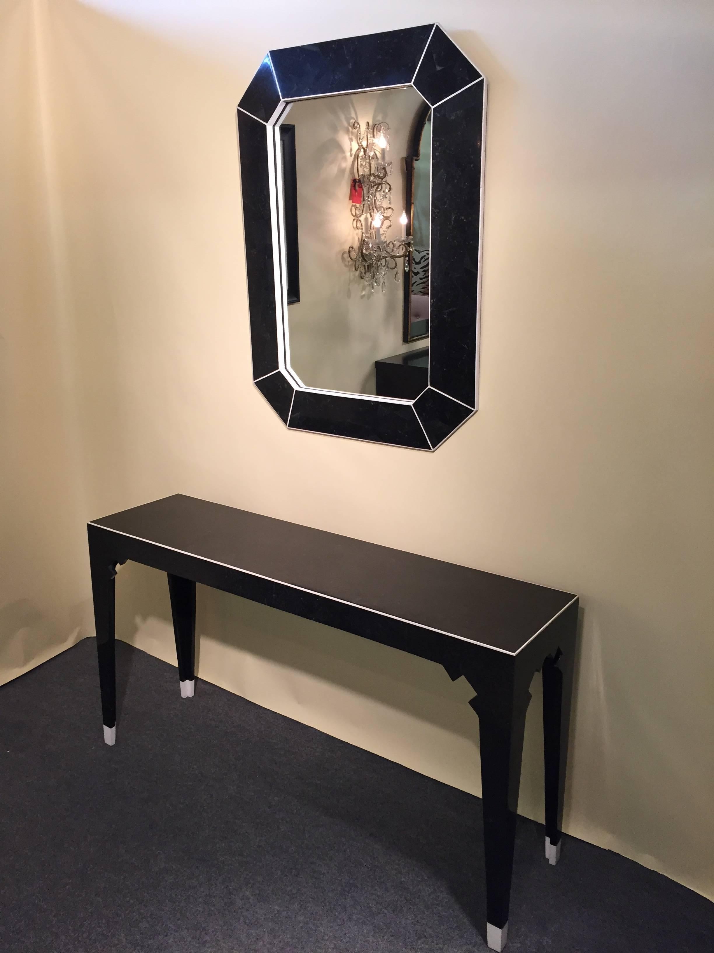 Gene Jonson and Robert Marcius black and white fossil stone geometric inlaid console with matching mirror. Completely covered with fossil stone, white stone edged, possibly.

The measurements for the mirror 40 high x 30 wide x 1.75 deep.