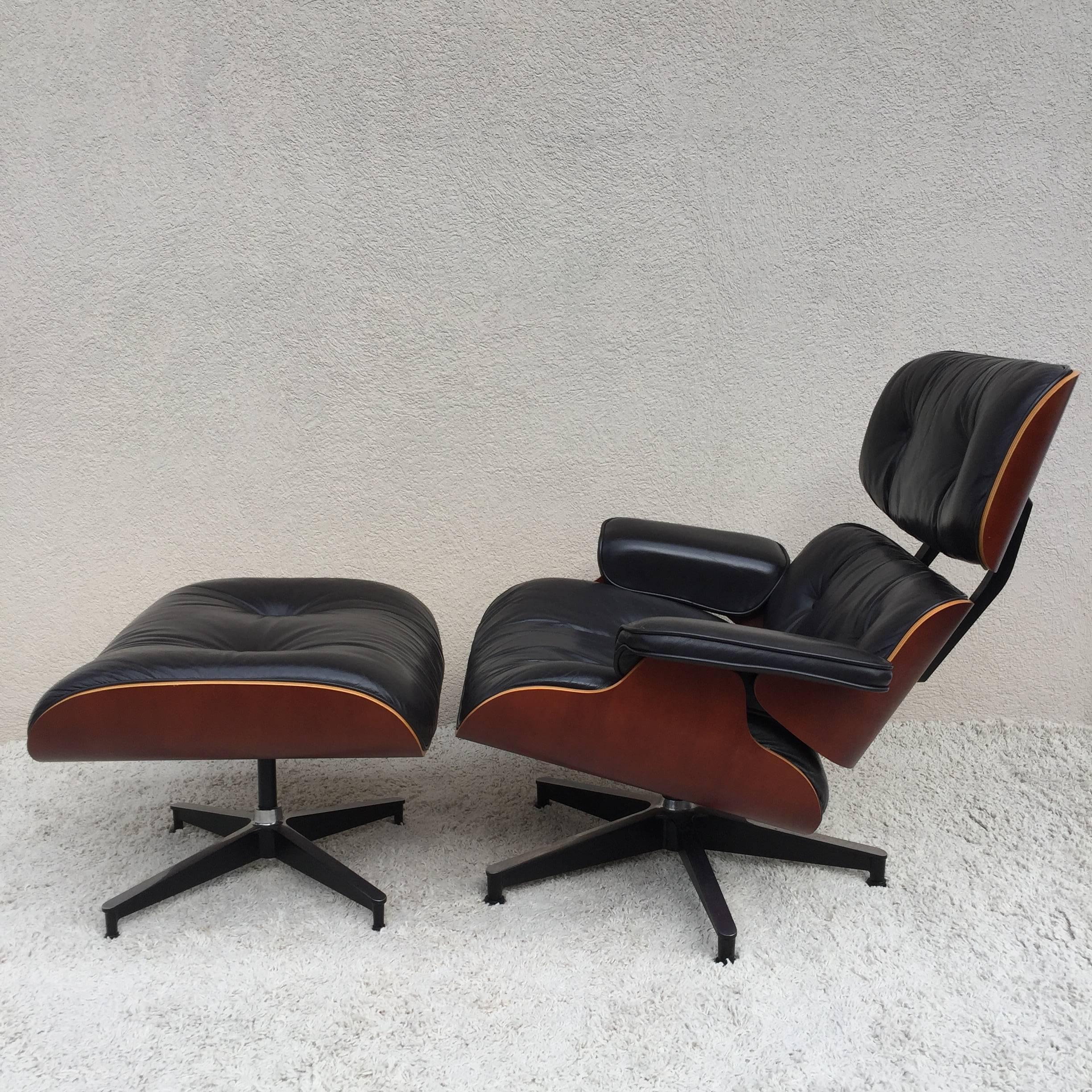 Charles Eames lounge chair and ottoman for Herman Miller, with black leather and cherrywood shell and light wood edge.

Ottoman size is 25.50 wide x 22.50 deep and 16.50" high.