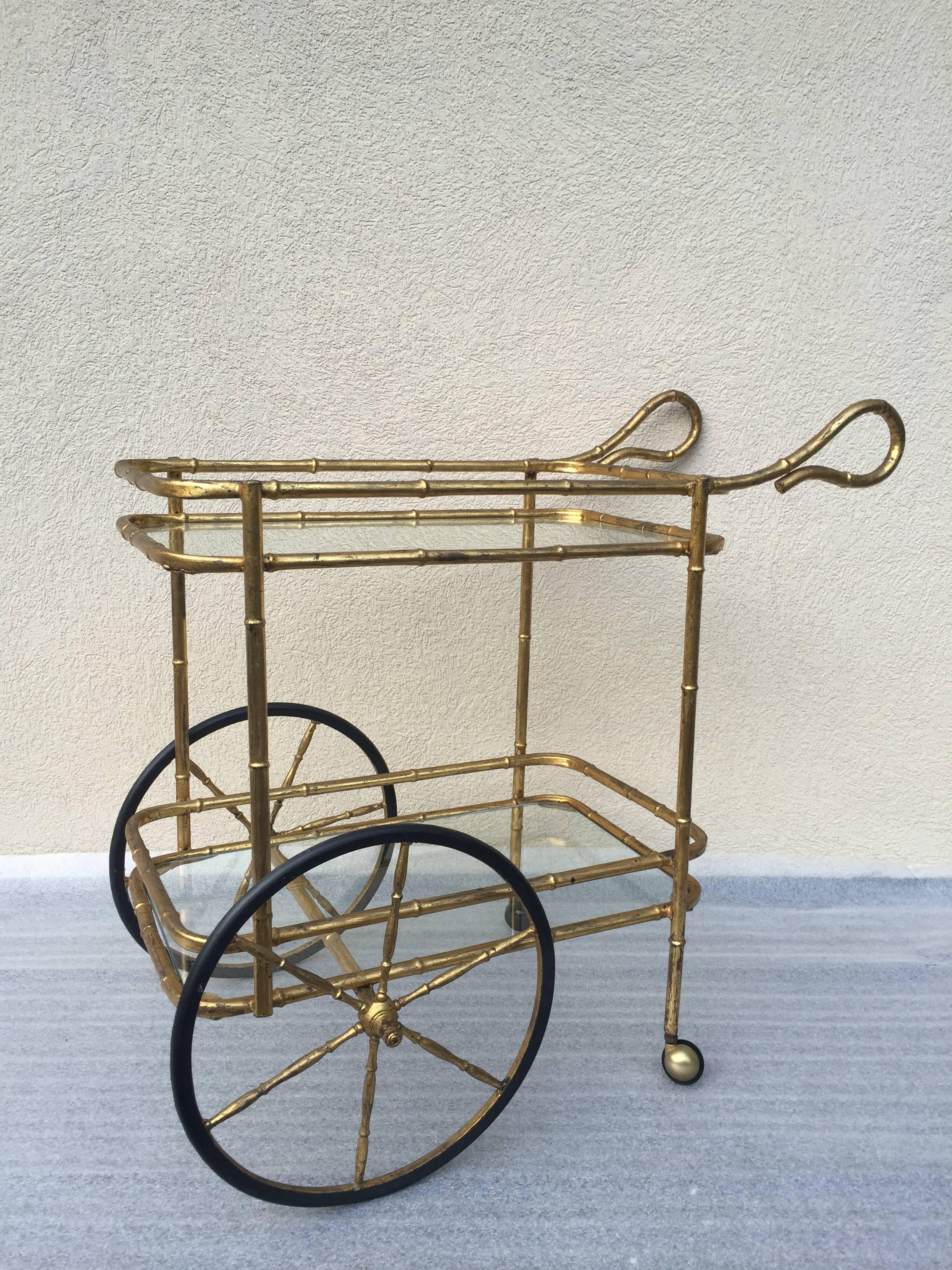 Gilt bamboo iron rolling bar cart two-tier, with large rubber wheels and curled arms. Petite design.