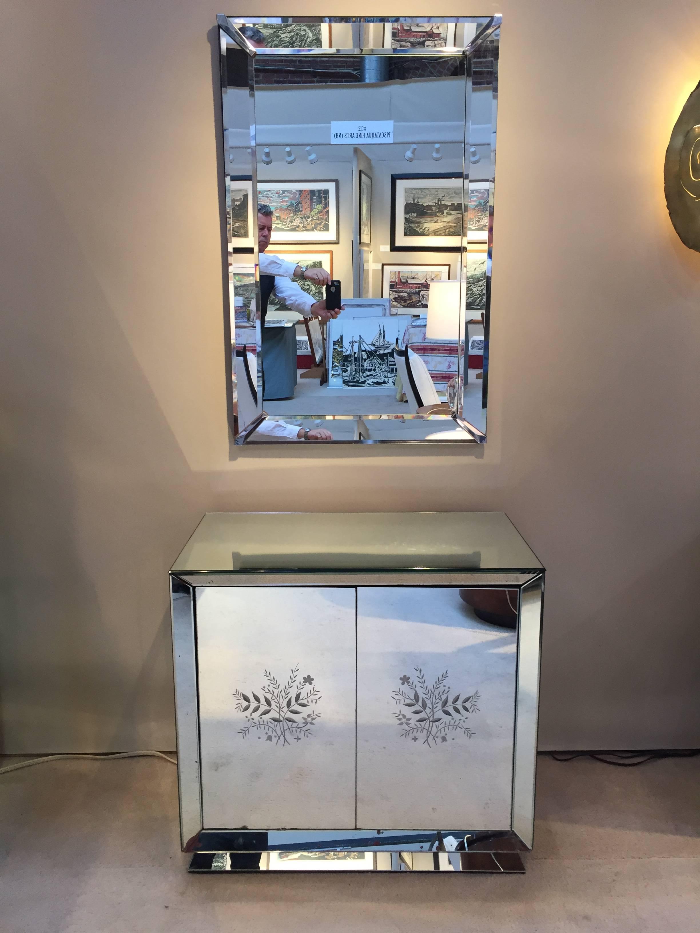 Art Deco etched mirrored bar cabinet with hidden revolving door compartment, bottle holder and mixing compartment.