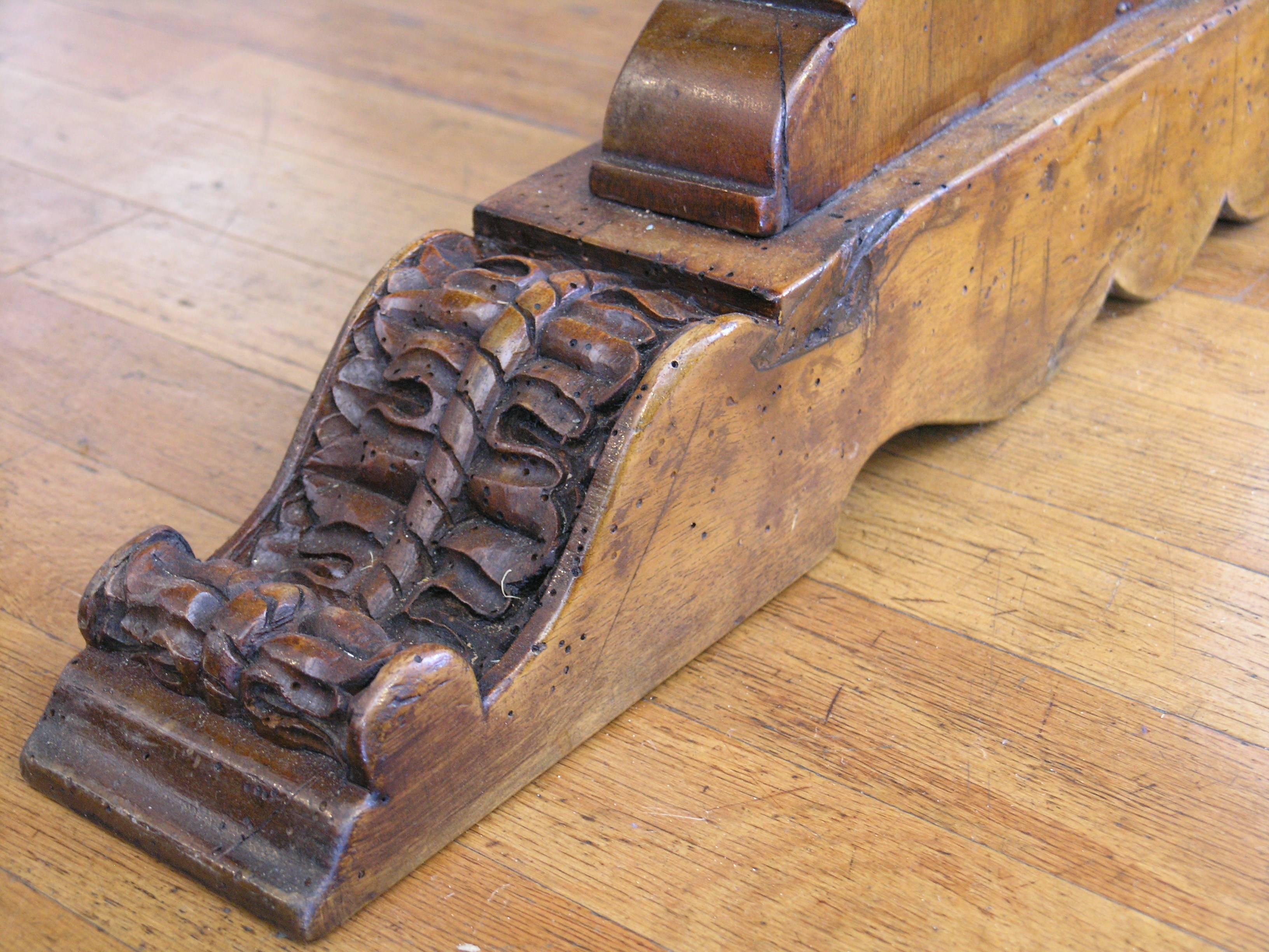 The rectangular top with molded edge above a fluted frieze and raised on shaped end supports joined by a stretcher on sleigh legs.