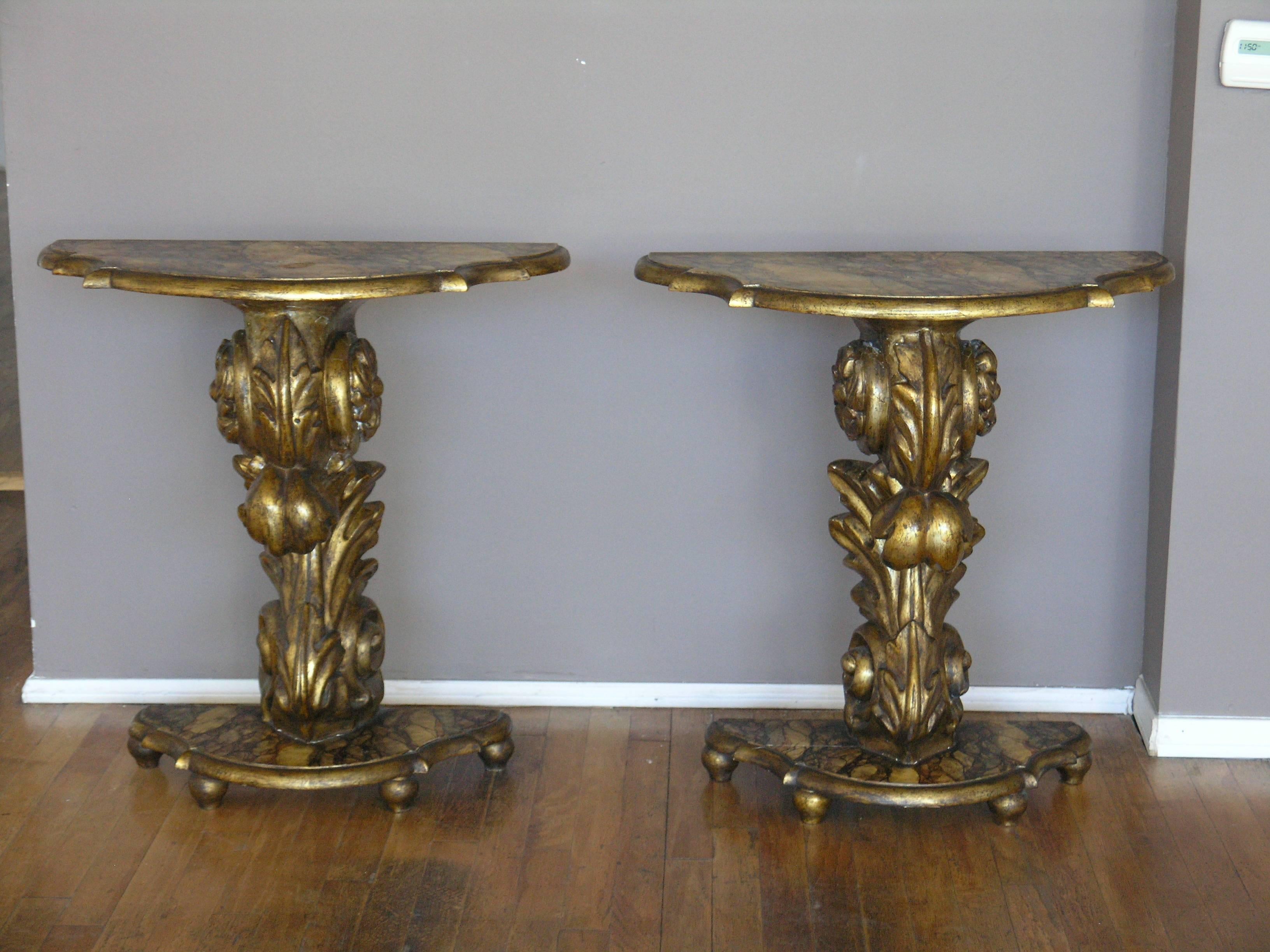 Shaped faux marble top above a scrolling carved volute resting on faux marble base.