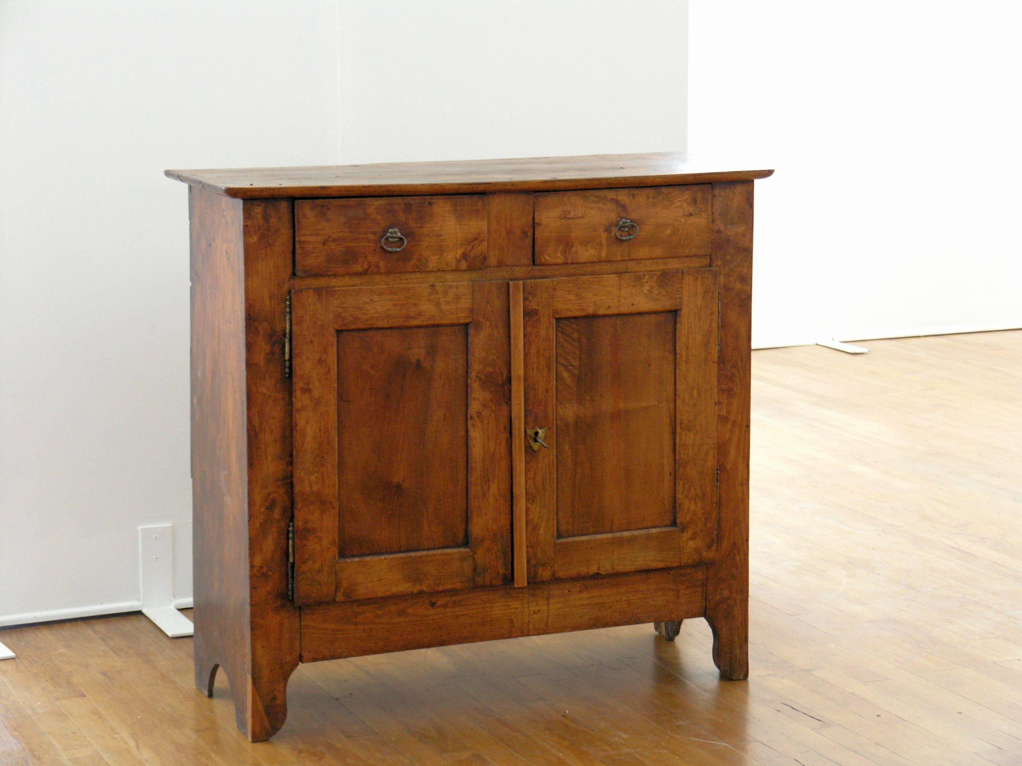 Rectangular top with molded edge over two drawers above two paneled doors raised on brackets feet.