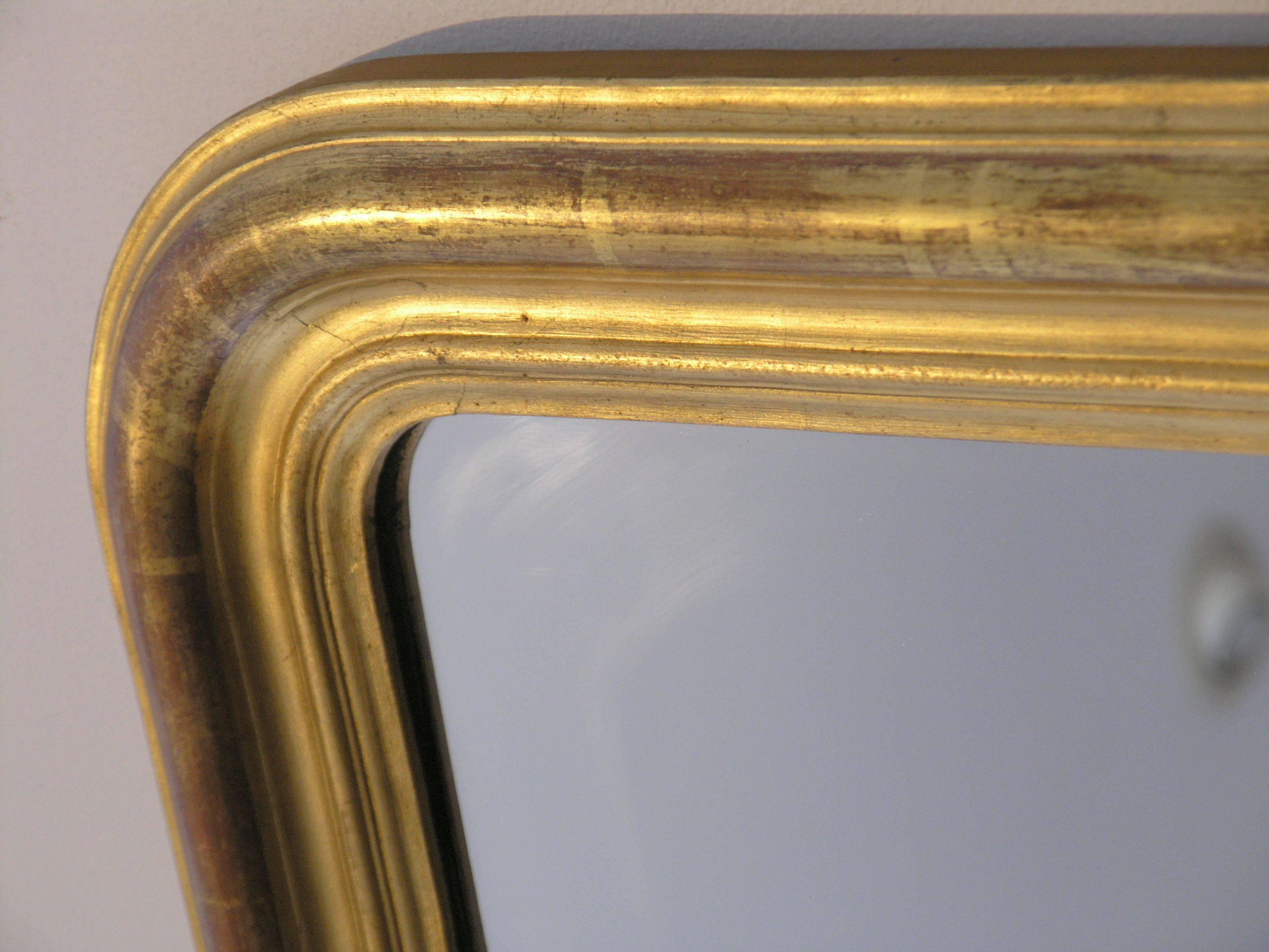 The arched rectangular plate within a molded giltwood border 