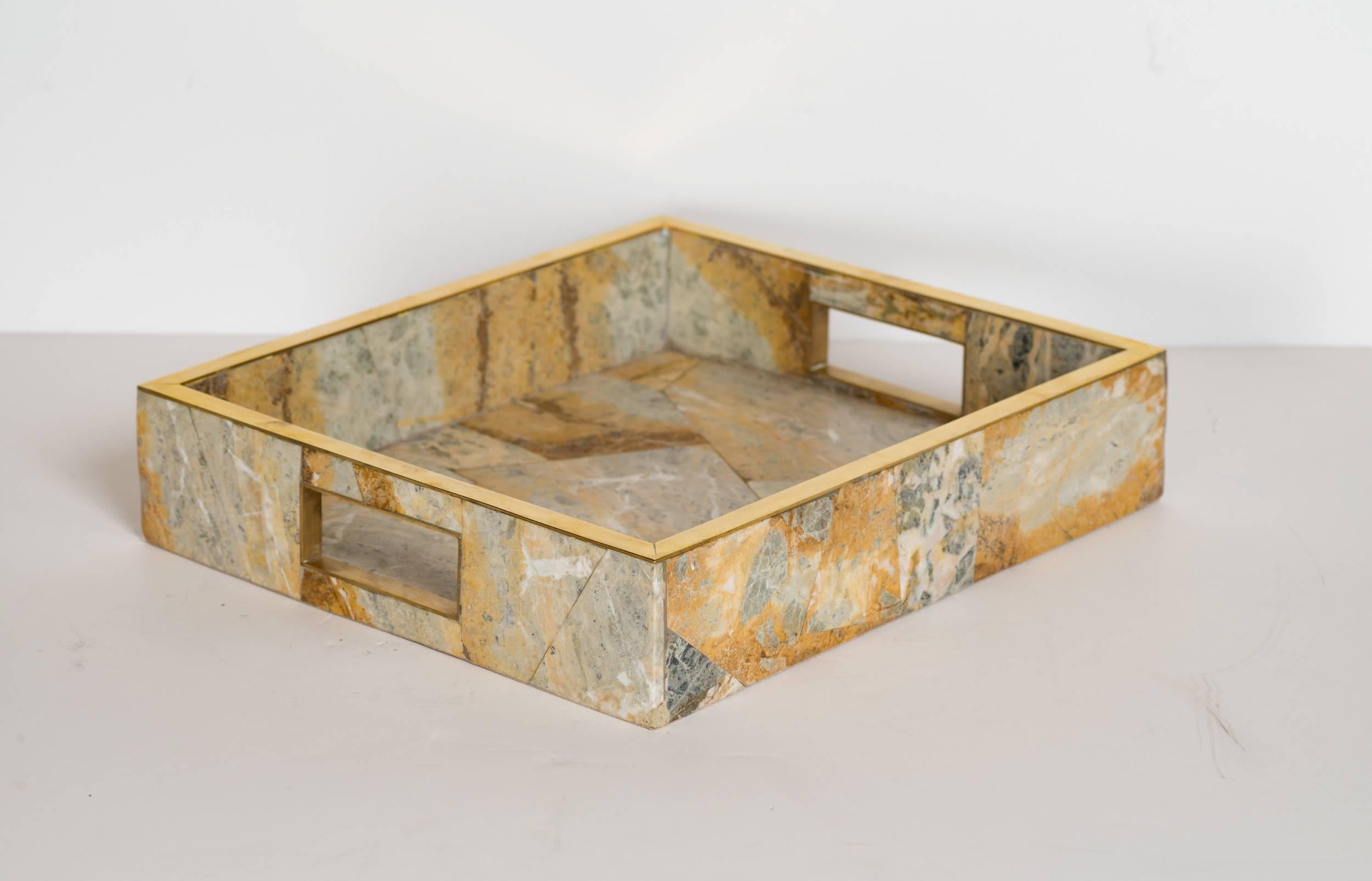 Stunning organic stone tray with mosaic patterns and geometric design. Beautiful streamline details with brass trim accents and handles. The onyx elements feature a variety of hues of brown, sand, rust, ivory, and gradient shades of green marble.