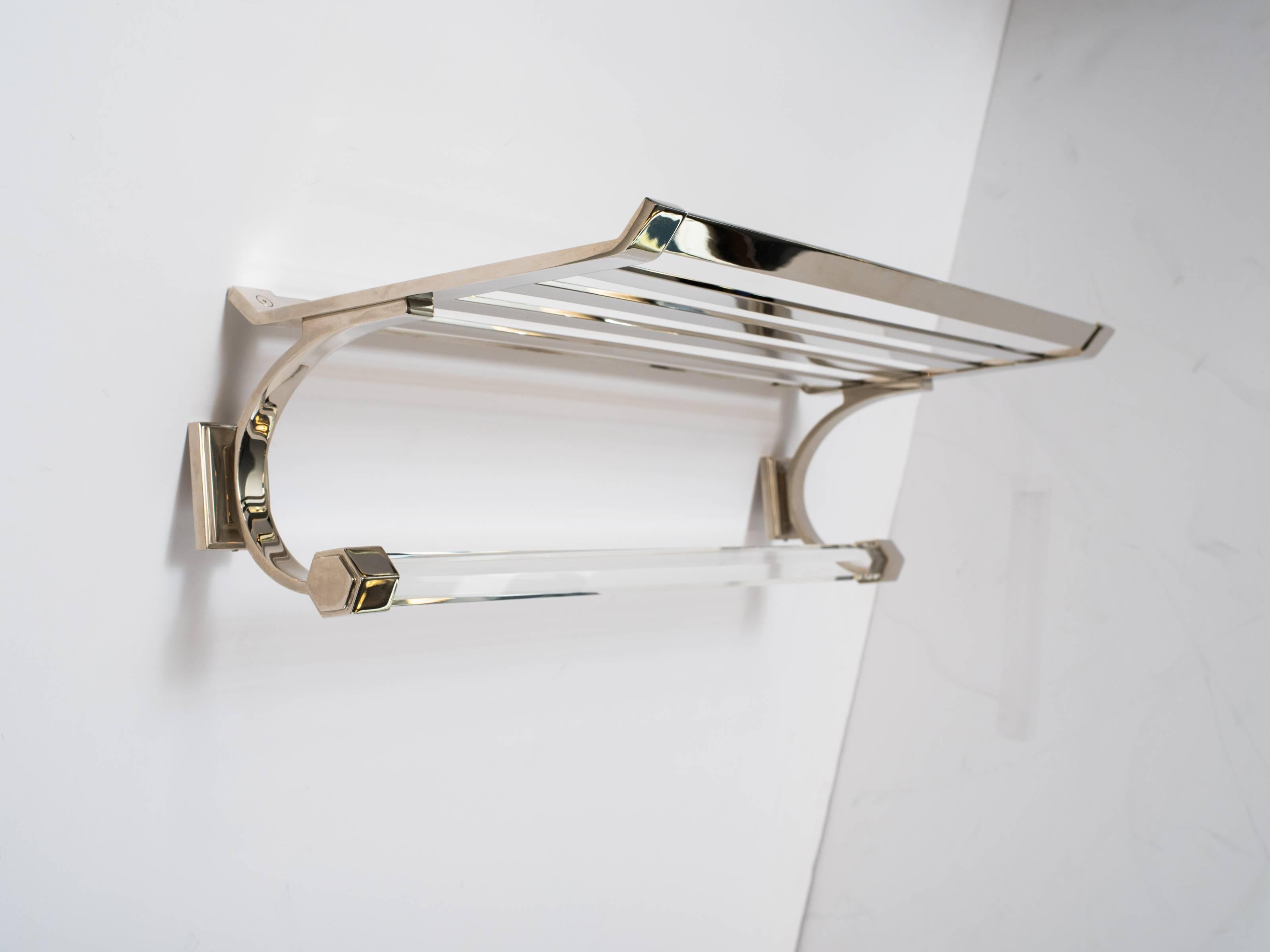 Modernist towel rack or bathroom shelf in polished nickel finish. The rack features a beautiful glass bar with faceted design, and a top rack with horizontal slats. Wall mount design rectangular backplates and curved sides with hexagon fittings.