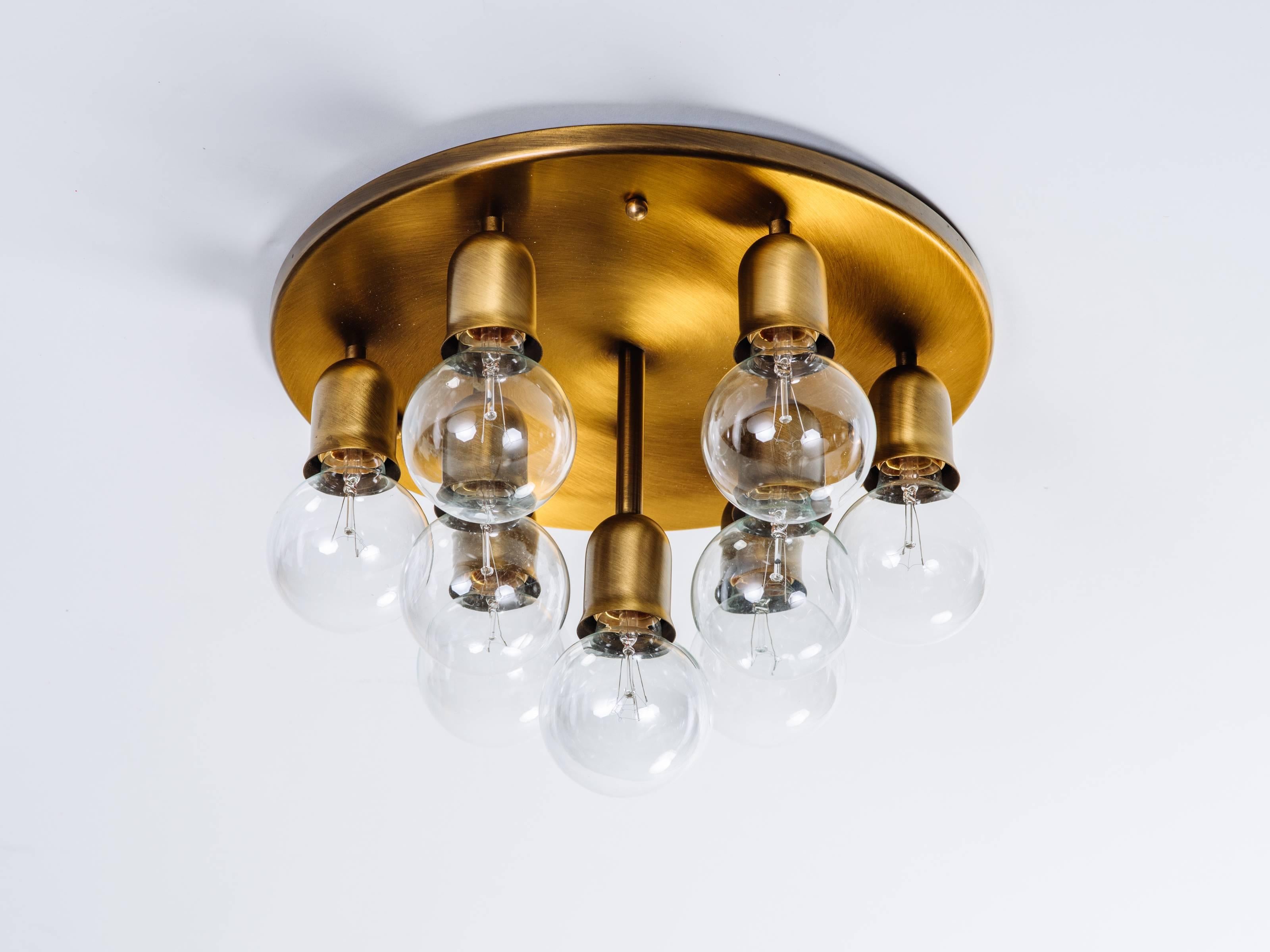 Mid-Century Modern round ceiling light or wall sconce, with sculptural Sputnik design. Fixture has a dark brass or brushed bronze metal finish, and is fitted with ten lights. Light sockets hang at varying heights to create atomic form.