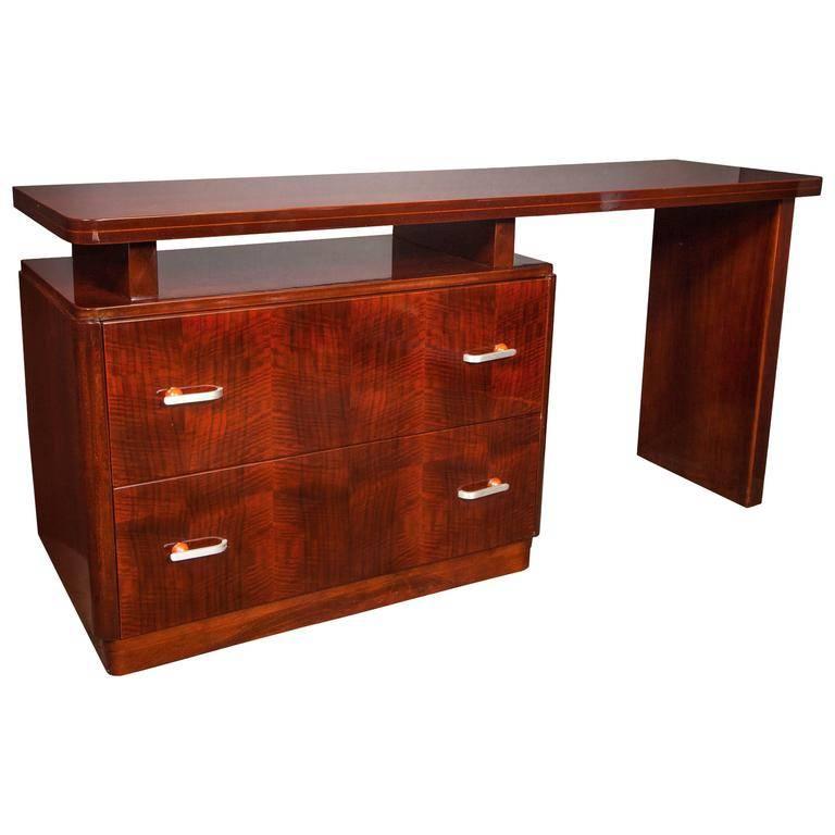 Machine age desk or vanity and dresser made in beautiful book-matched mahogany wood. The desk features a long and floating streamlined top with rounded corners. Fitted with two large storage drawers or dressers. The drawers have brushed aluminium