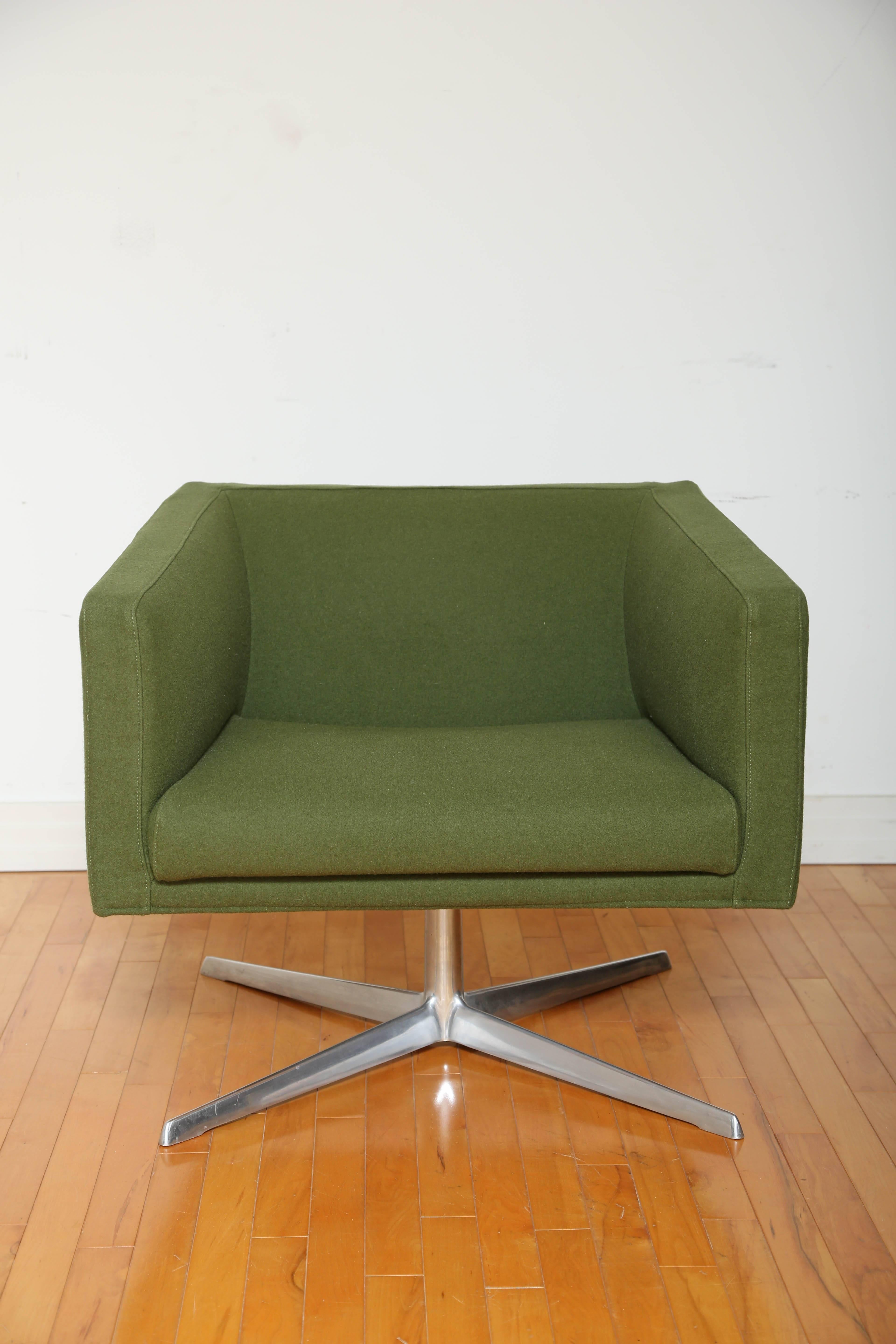 Cubica swivel armchair by Verzelloni. Features Mid-Century Modern design with cubist form, and full 360 degree swivel. Streamline design lends itself to both home or office setting. Upholstered in army green wool blend fabric with four legged