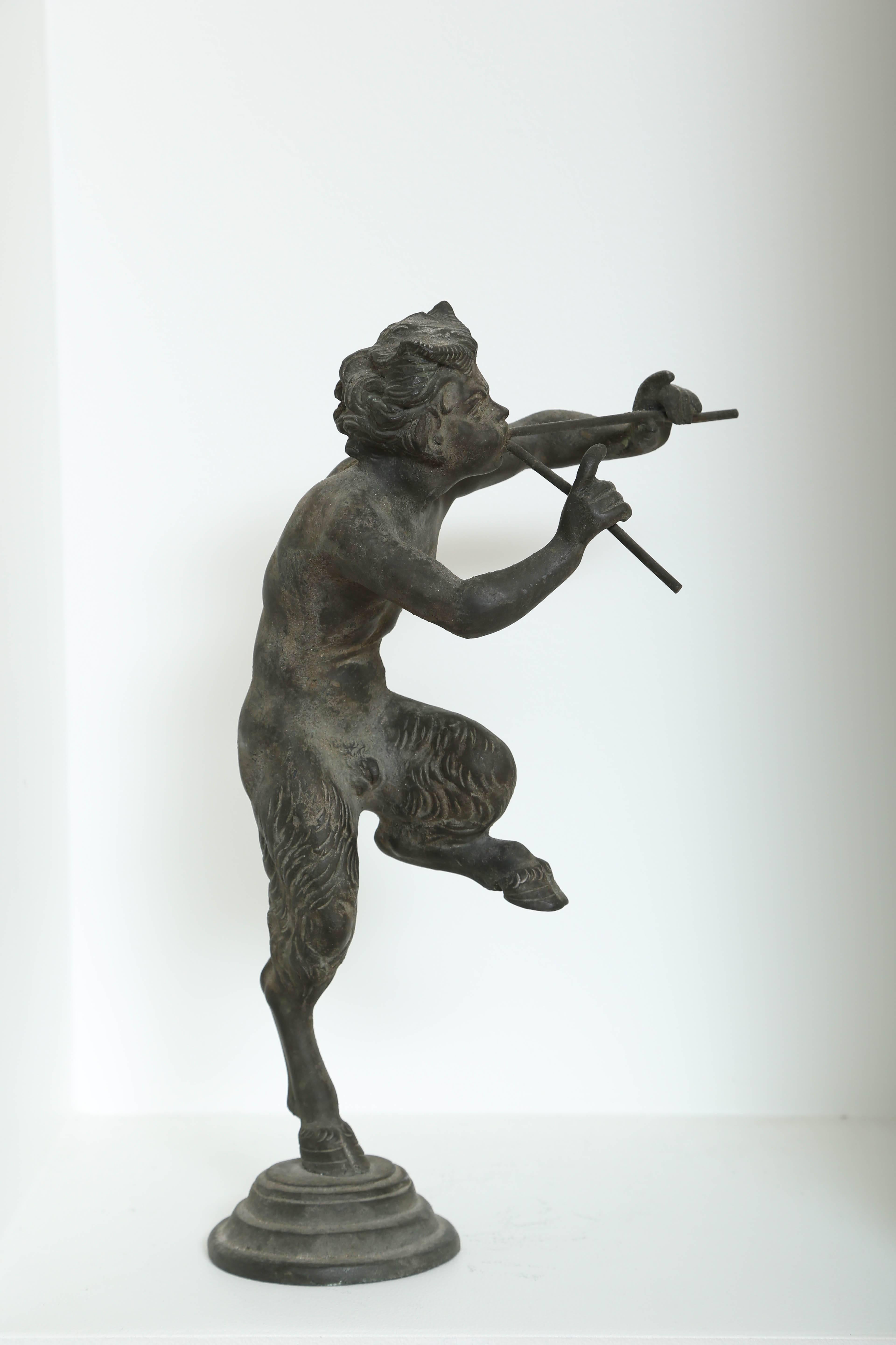 Rare antique bronze statue of Pan the Greek/Roman fertility God of the forest, from the personal collection of Juan March of the Fundación Juan March (Juan March Foundation). The sculpture features Pan half-man, half-goat playing a pair of flutes.