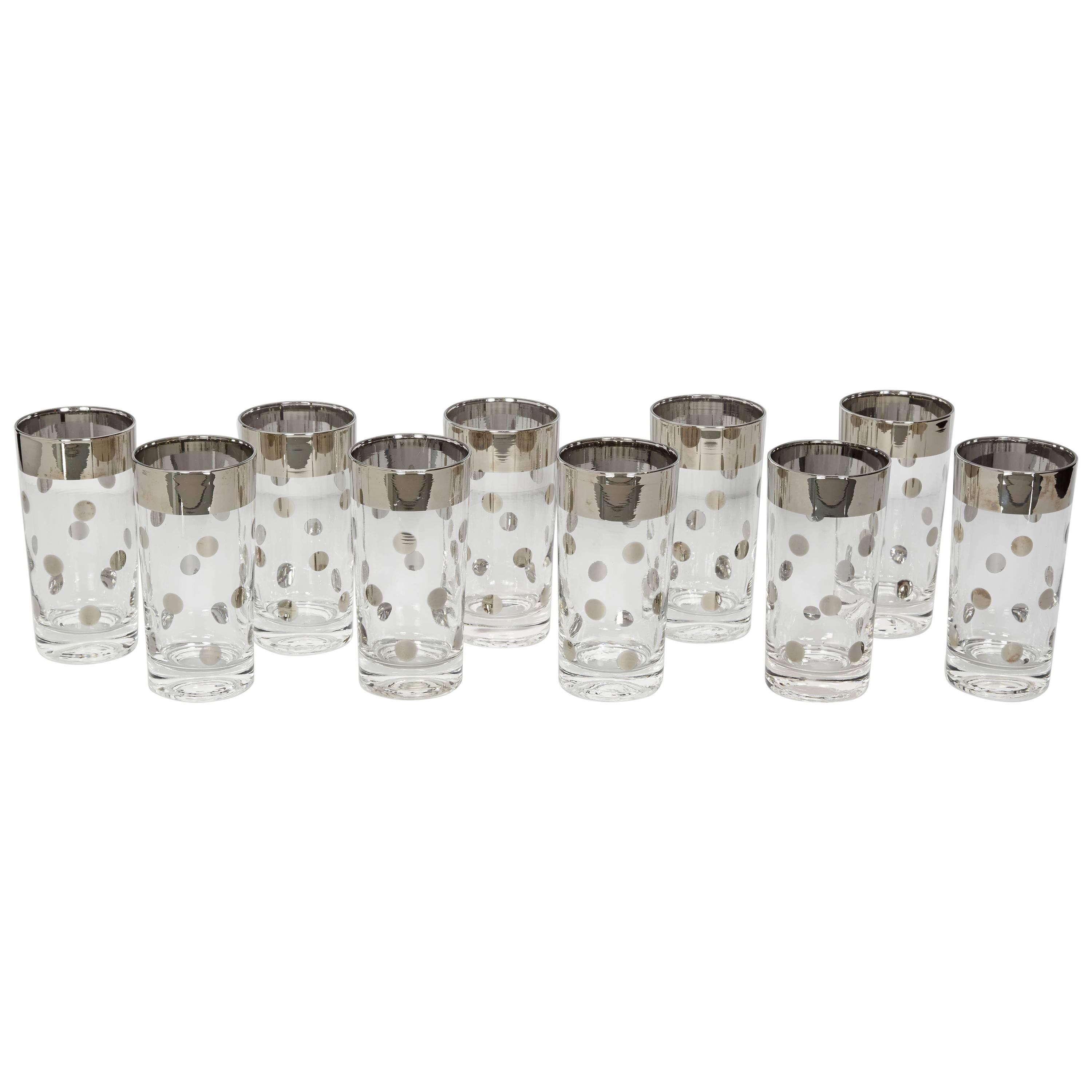 Mid-Century Modern barware glasses consisting of ten tall tumbler glasses. The glasses have a silvered gunmetal trim detail with polka dot design. Adds a smart and cheerful addition to any bar set or dinnerware set.