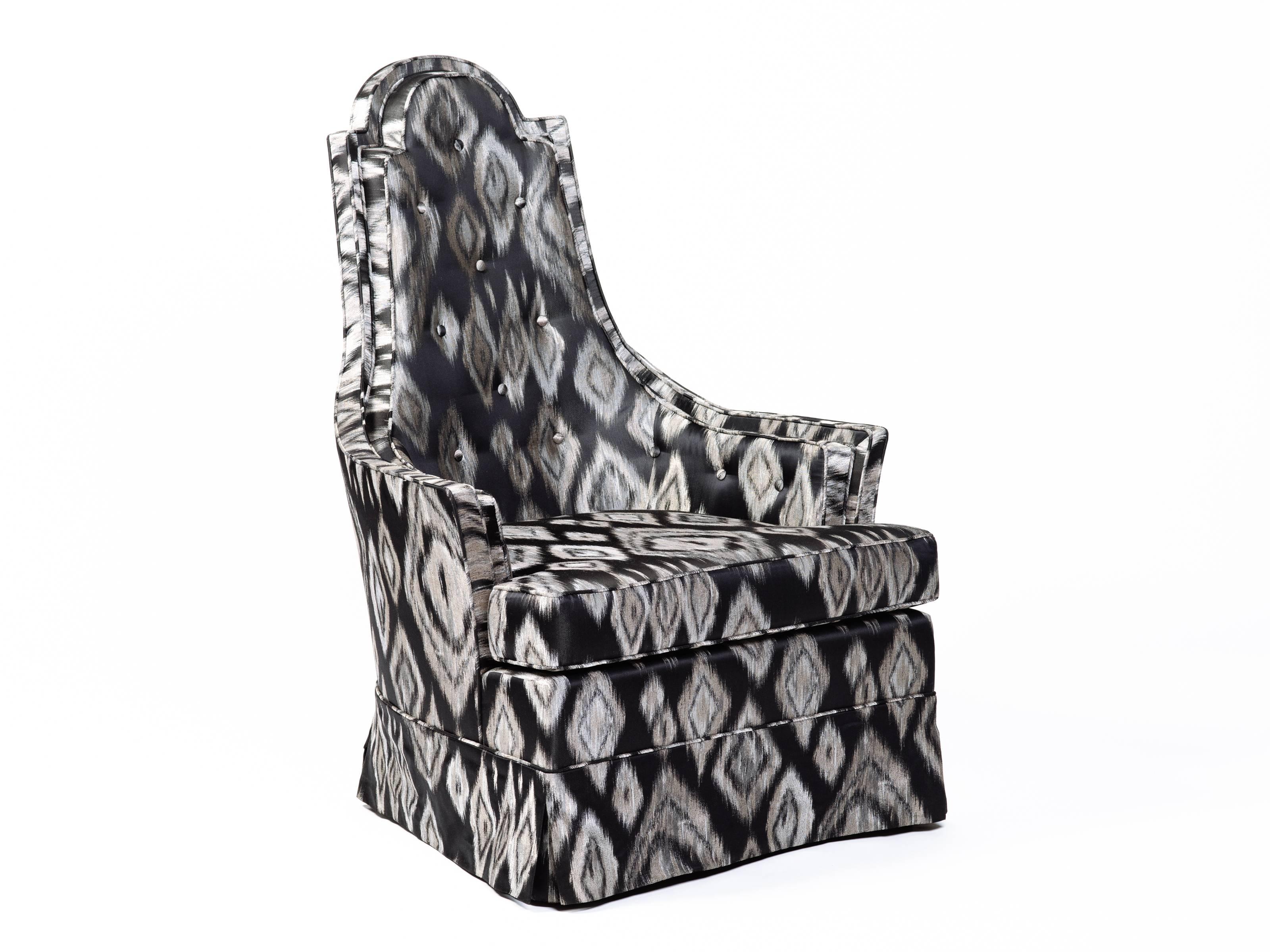Pair of Mid-Century Modern armchairs with sculptural high back design. Newly upholstered in graphic black and platinum Ikat silk fabric with geometric print. Chairs have tall shield shaped backs with a gorgeous profile. Features button back accents