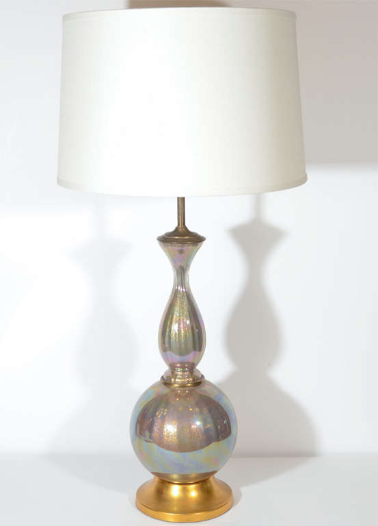 Hollywood Regency handblown Murano glass lamp with iridescent gold flecks. Moorish inspired design with genie bottle form. This beautiful lamp has a gilt metal base with patinated bronze fittings and cinched long neck design. Shown with custom drum
