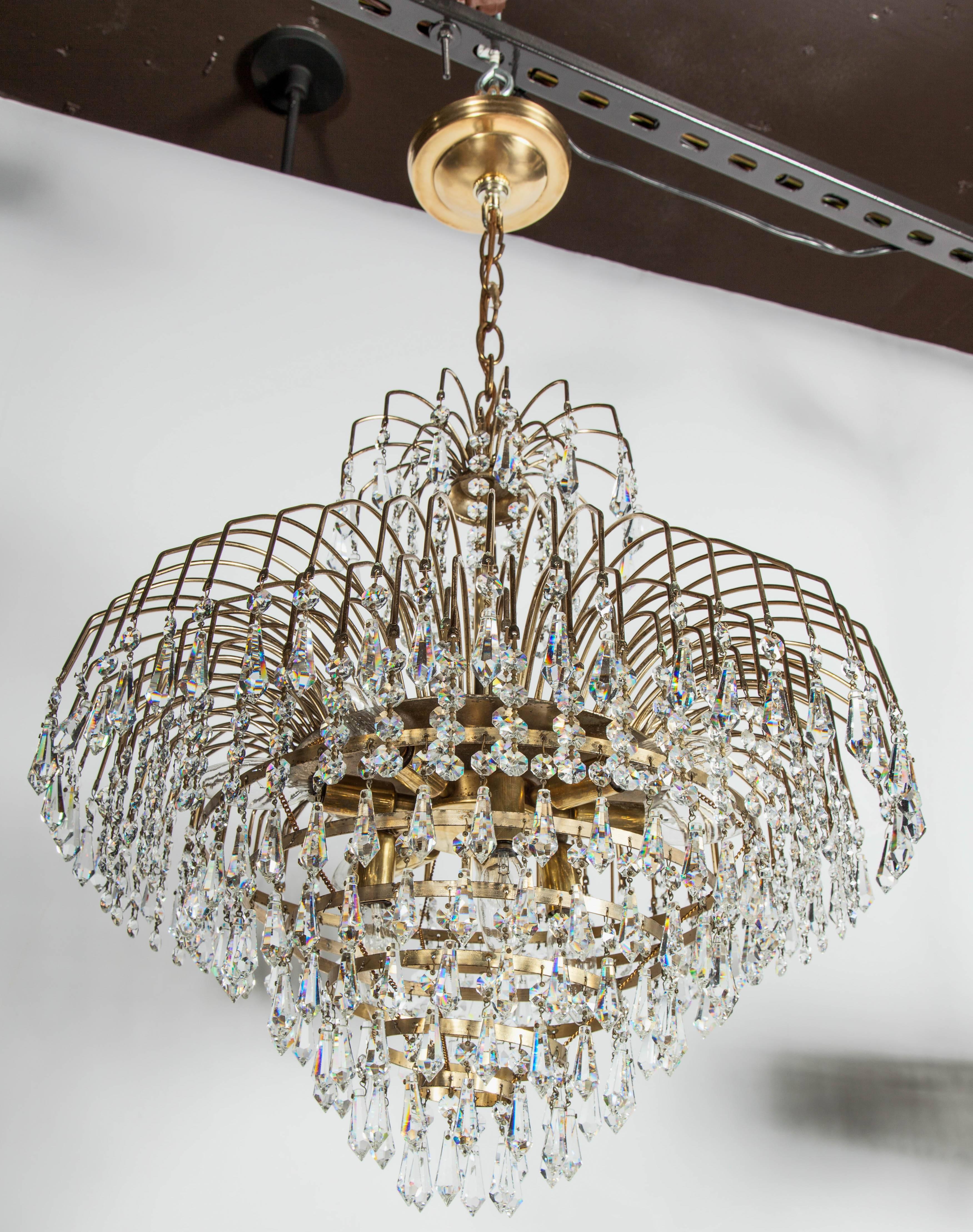 Mid-Century Modern waterfall chandelier with spectacular cut crystals throughout. Features a brass frame with multiple cascading tiers, fitted with hundreds of suspended cut crystal pendants and crystal beads. The frame is comprised of ten-tier in