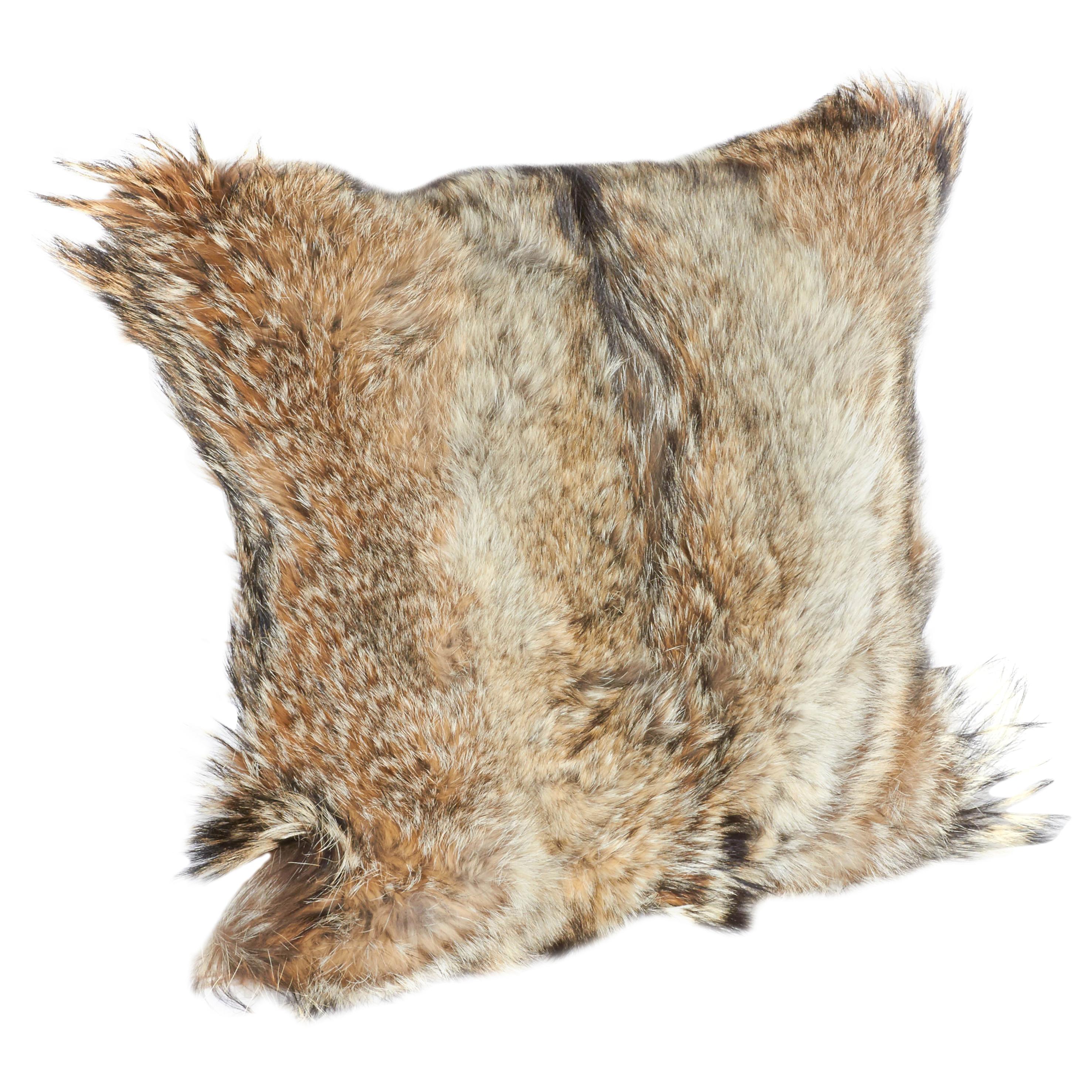 Luxury throw pillow handcrafted from genuine coyote fur in rich hues of tan, beige, ivory, and brown, with the occasional black streaks. Each pillow is unique in coloration and texture, and features hand stitched backing in fine khaki colored