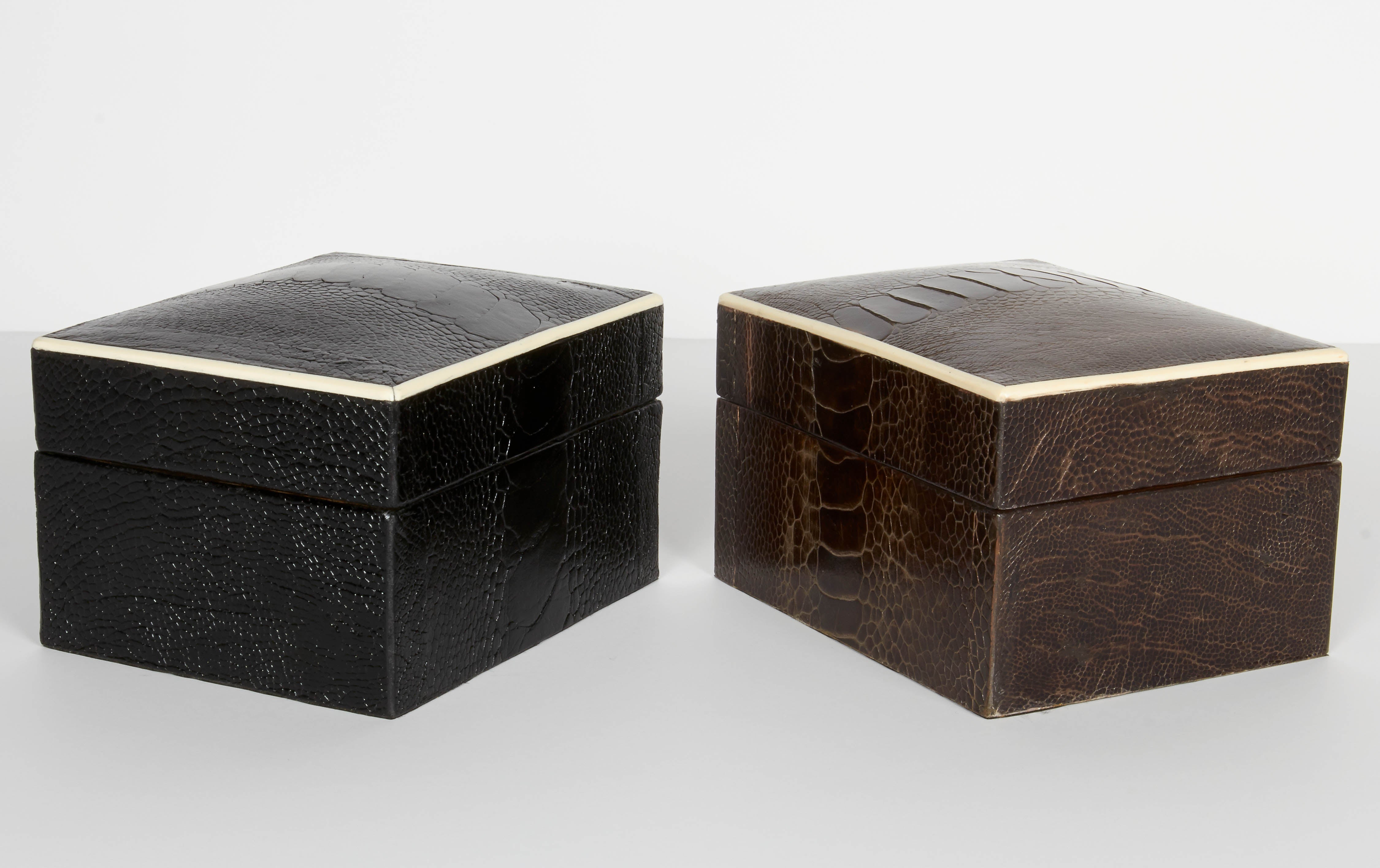 Stunning organic modern decorative boxes wrapped in exotic ostrich leather with bone inlay trim. All handcrafted in fine leather available in espresso brown or black ebony, with palm wood interiors. Mid-century modern style make great desk and