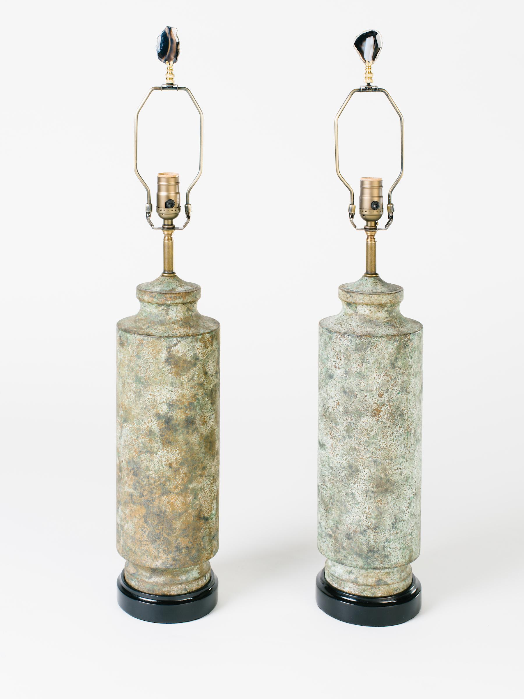 Pair of striking Mid-Century Modern lamps with Brutalist design. Lamps are made of cast iron and have Asian pagoda column forms. Metal has been purposely oxidized for a distressed look reminiscent of camouflage pattern in hues of moss green and
