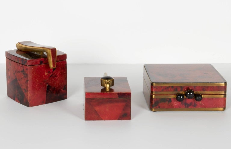 Modern decorative / jewelry box features exotic pen shell exterior, hand dyed and lacquered in rich jewel tones of ruby and muted black. All handcrafted with mosaic designs and geometric patterns. The box design features stylized hardware in bronze