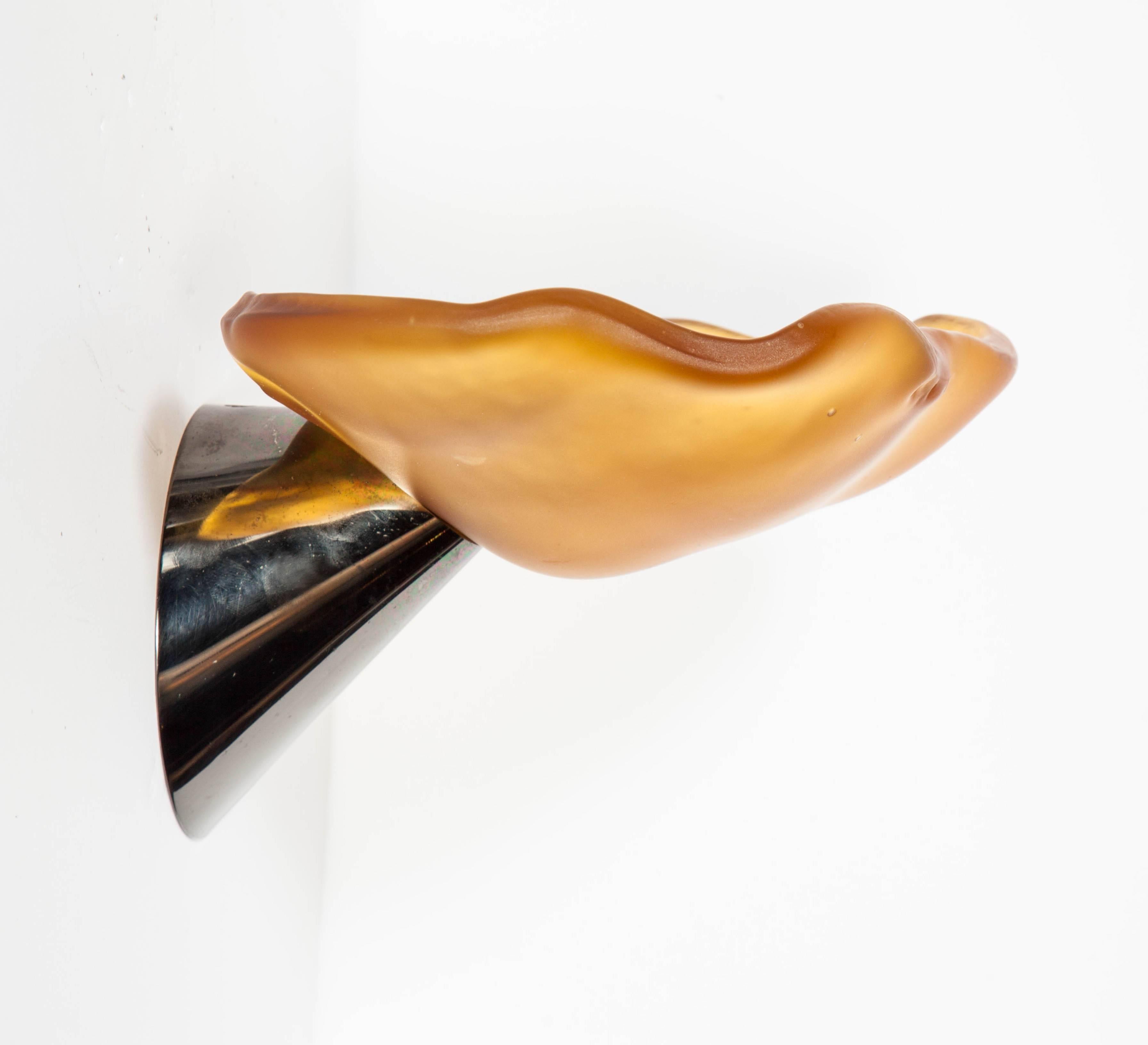 Pair of vintage Postmodern sconces with Art Nouveau inspired design. The sconces feature handblown Murano glass shades in amber with free-form water lily design. The sconces also have gunmetal tapered cone shaped bases. Fitted with one light each,