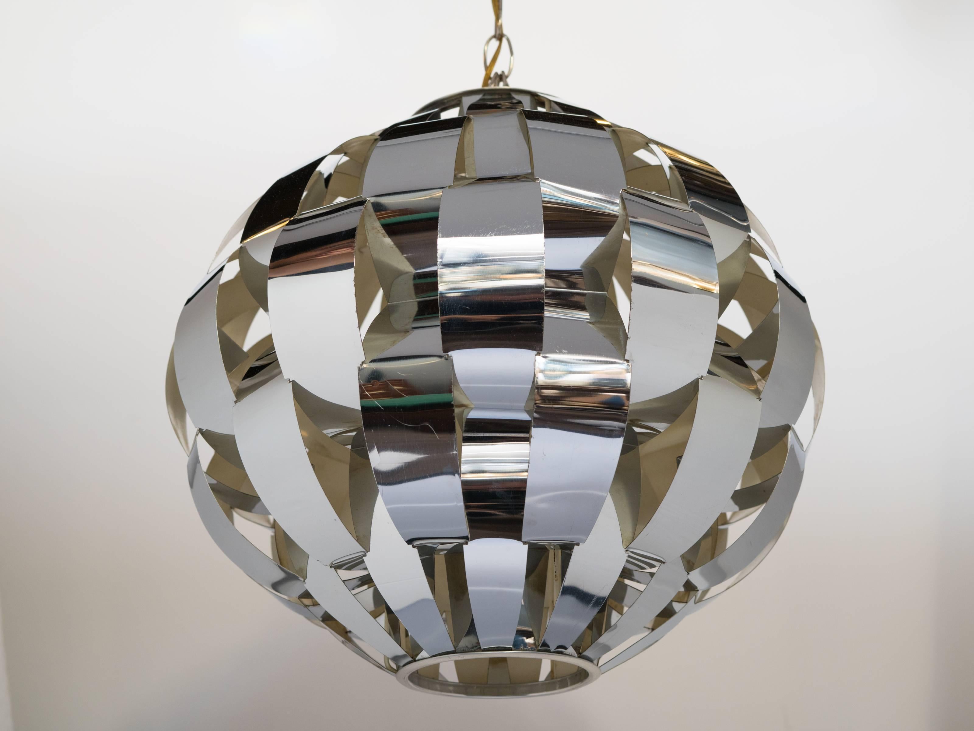 Iconic mid-century modern pendant light consisting of bent chrome metal forming a woven, ribbon design. Polished chrome with white enamel finished interior. Highly reflective along all the openings and features one central down light.