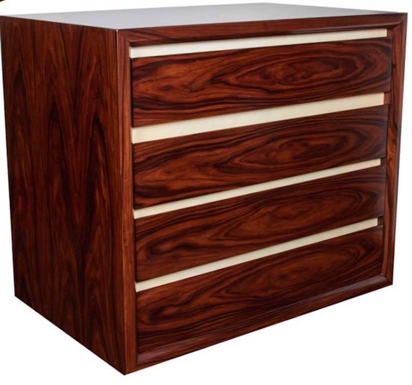 Exquisite dresser or chest comprised of exotic book matched rosewood with lacquered goatskin trim. Conveniently fitted with four drawers that feature a soft push-close. The chest has a mid-century modern inspired design with streamline form. Two