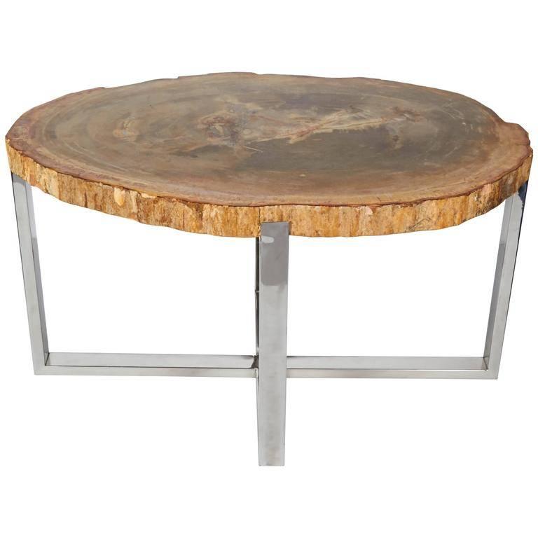 Organic side table or coffee table comprised of a solid slab of petrified wood, naturally fossilized throughout hundreds of years. Has a polished surface with natural raw edges. Fitted with custom chrome base with stylized X design. Remarkable