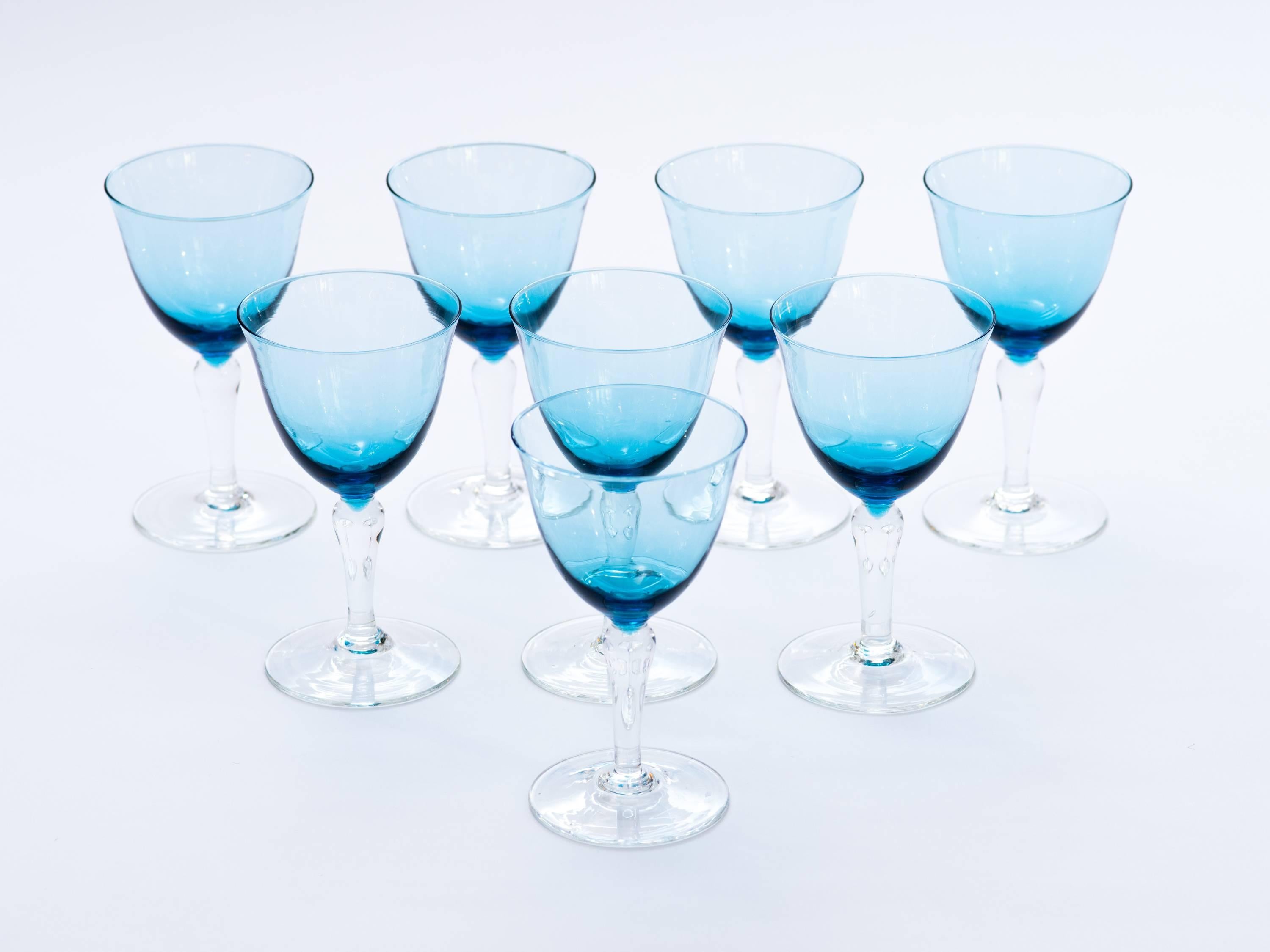 Set of eight mid-century modern wine glasses or water goblets in stunning aquamarine hues. Hand blown with stylized clear glass stems.