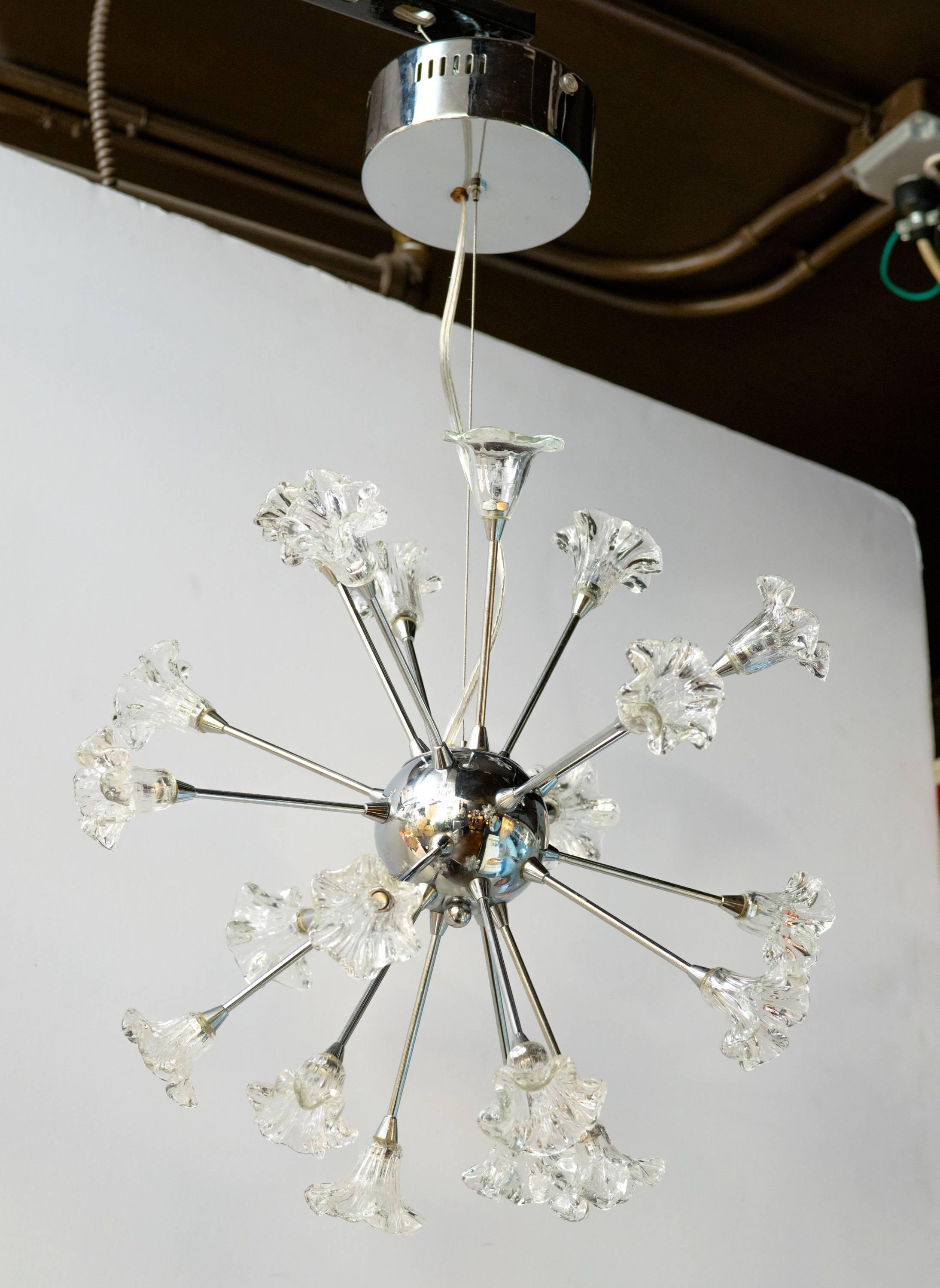 Mid-century modern chandelier with atomic design in polished chrome. Fitted with 20 blown glass shades with stylized floral designs. Each floral component is fitted with an individual light (20 total). 