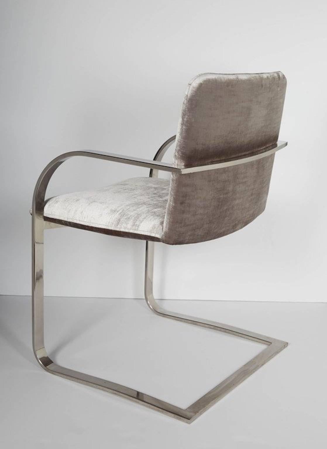 Mid-Century modern desk chair with cantilevered frame design. Chair has streamlined profile with curved armrests and floating seat details. The chair is made of a polished steel frame. Newly upholstered in luxe platinum velvet-cotton fabric.
      